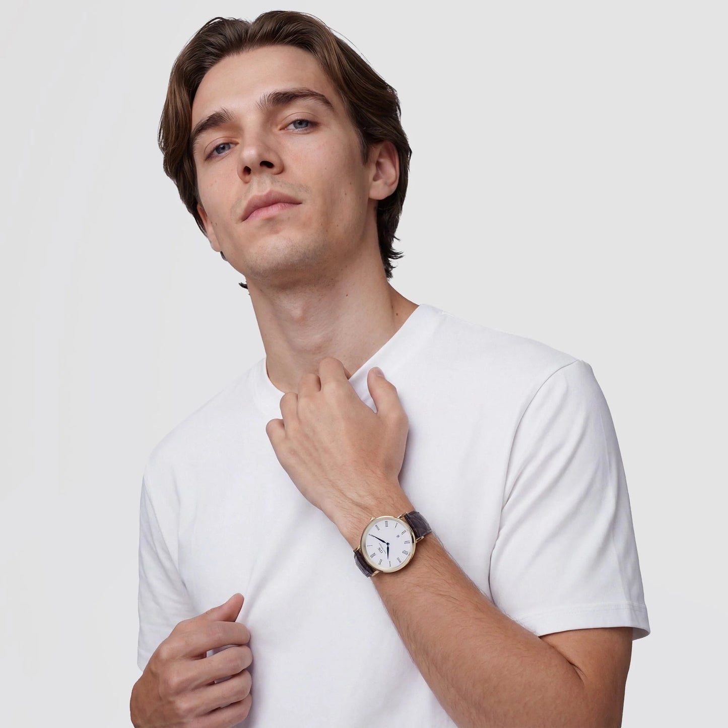 Daniel Wellington Classic Roman Numerals Date watch with dark brown crocodile strap and 40mm case on a white background.