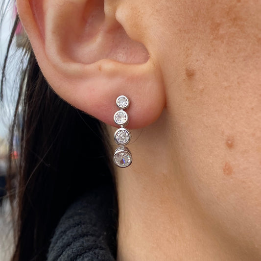 Silver Insignia four-stone graduated CZ drop earrings with elegant design and sparkling gemstone accents.
