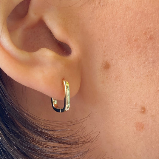 Sunshine rectangular huggie hoop earrings by Comero, gold-tone earrings with a modern rectangular design, close-up view.