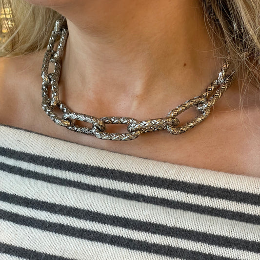 Silver necklace by Industrie Testi featuring a stylish design, displayed on a neutral background.