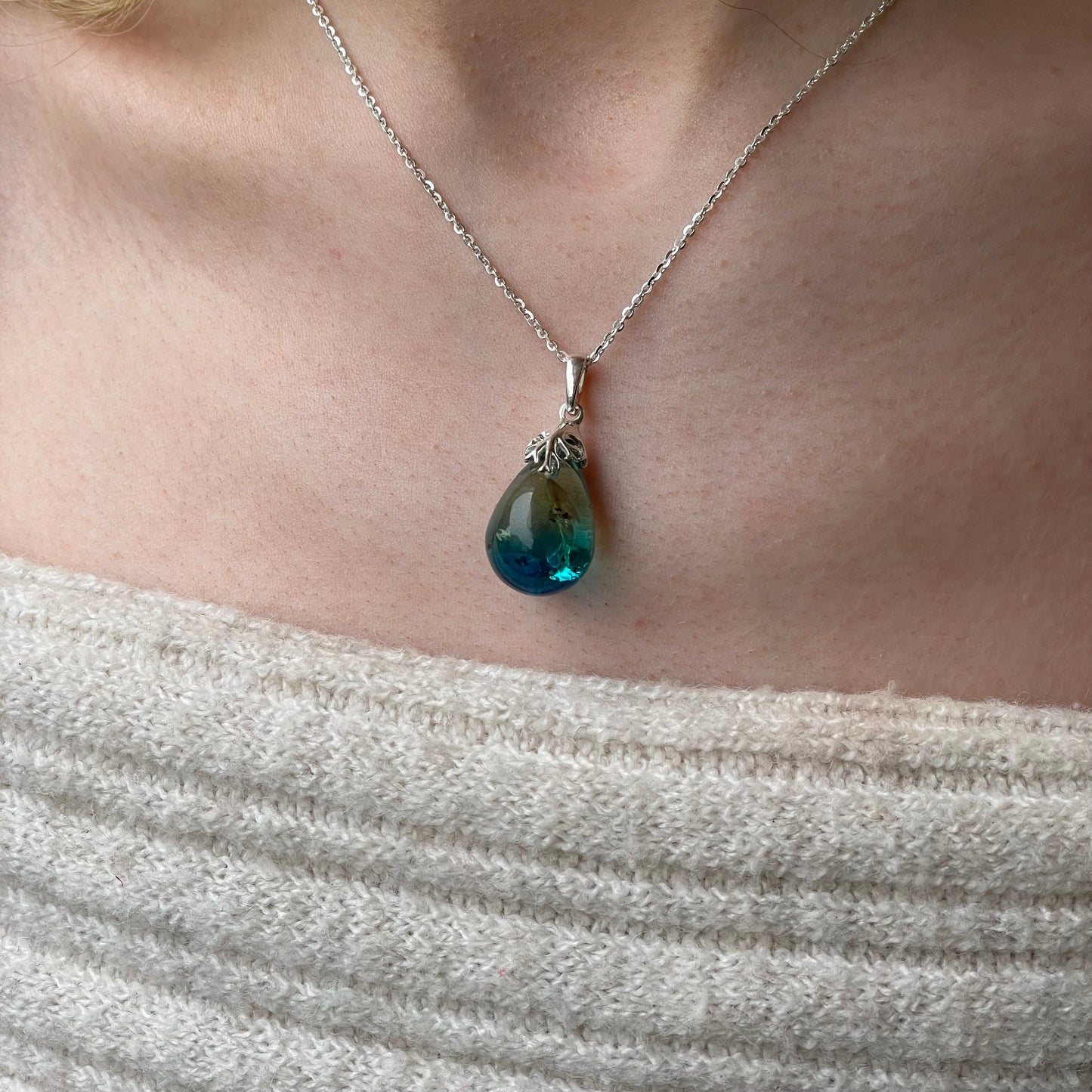 Silver Baltic Amber pendant necklace featuring a polished amber stone on a silver chain by CME.