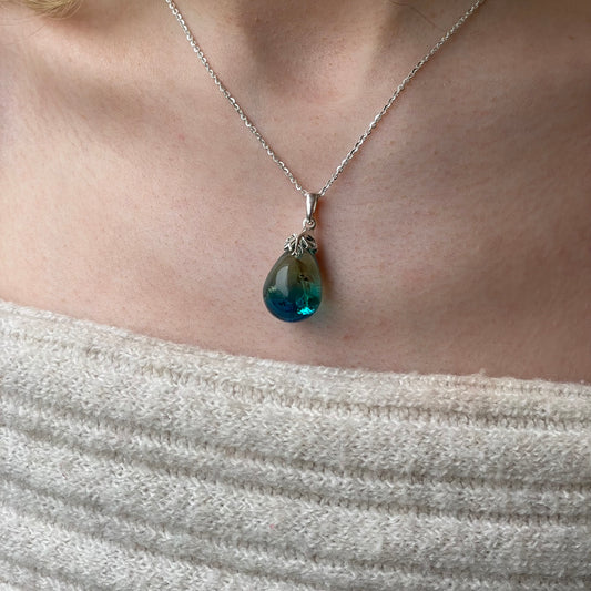 Silver Baltic Amber pendant necklace featuring a polished amber stone on a silver chain by CME.