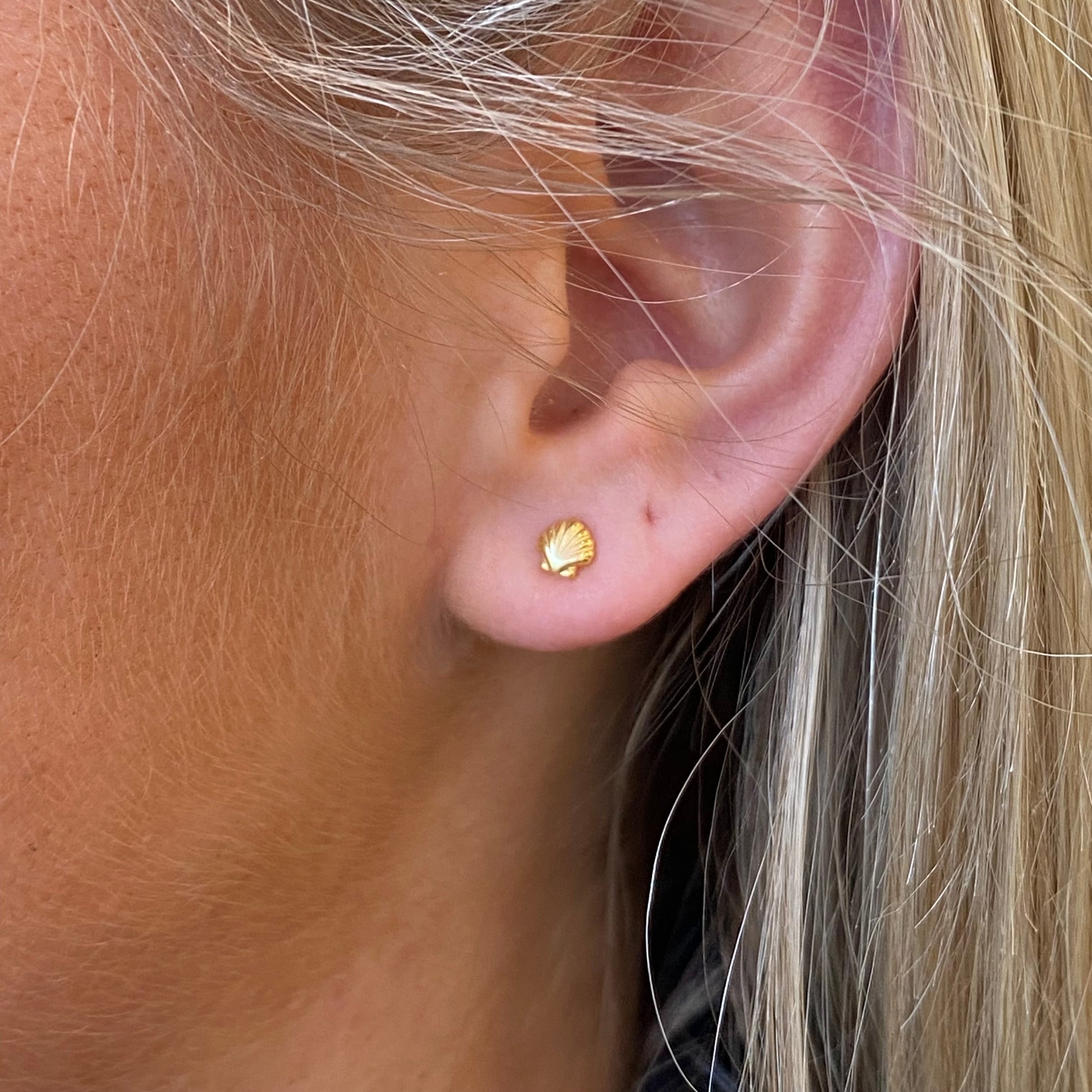Sunshine Shell Kid's Stud Earrings by Comero featuring small, round shell design with a shiny gold-tone setting.