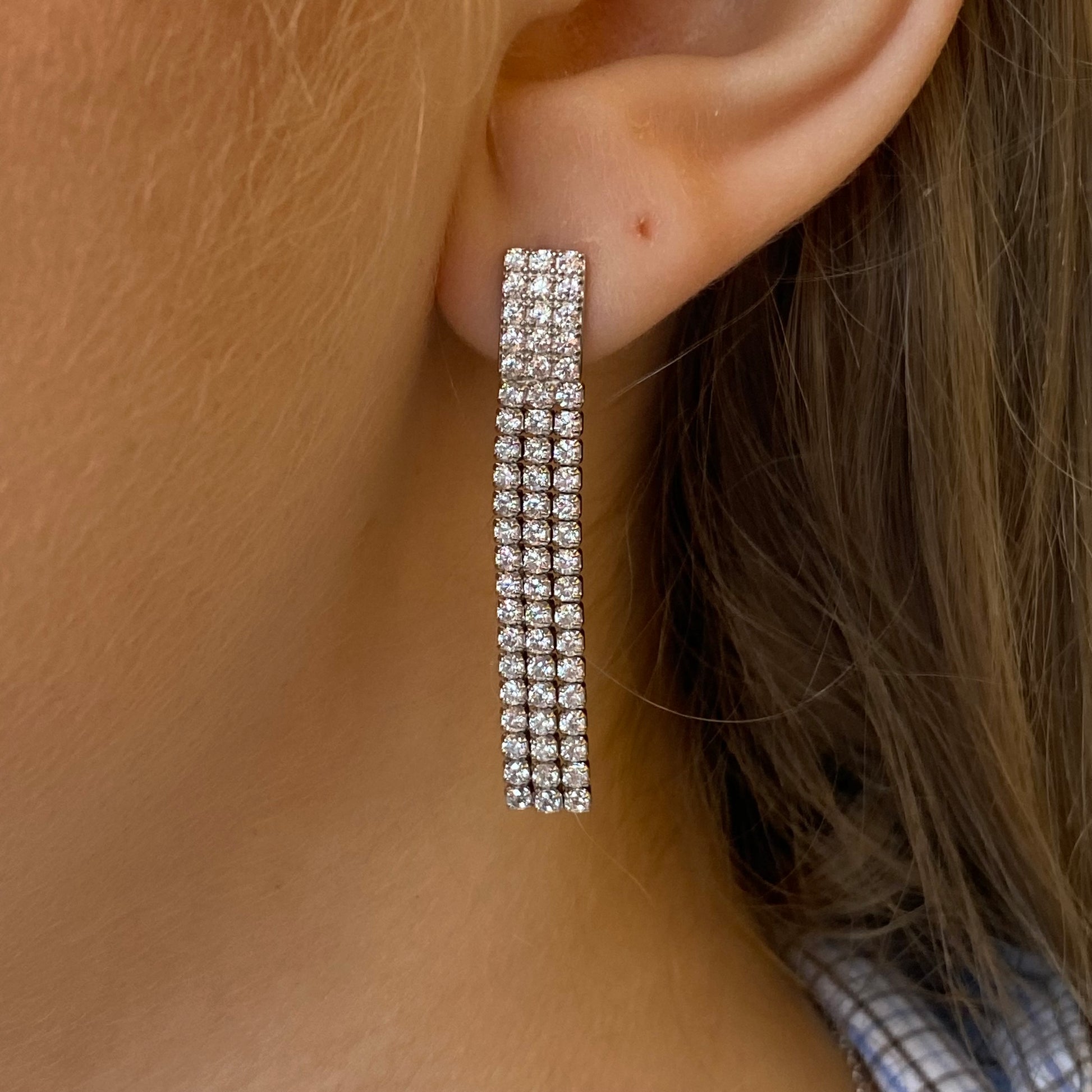 Silver long tennis drop earrings by Comero featuring sleek, elegant design with sparkling accents for a stylish look.