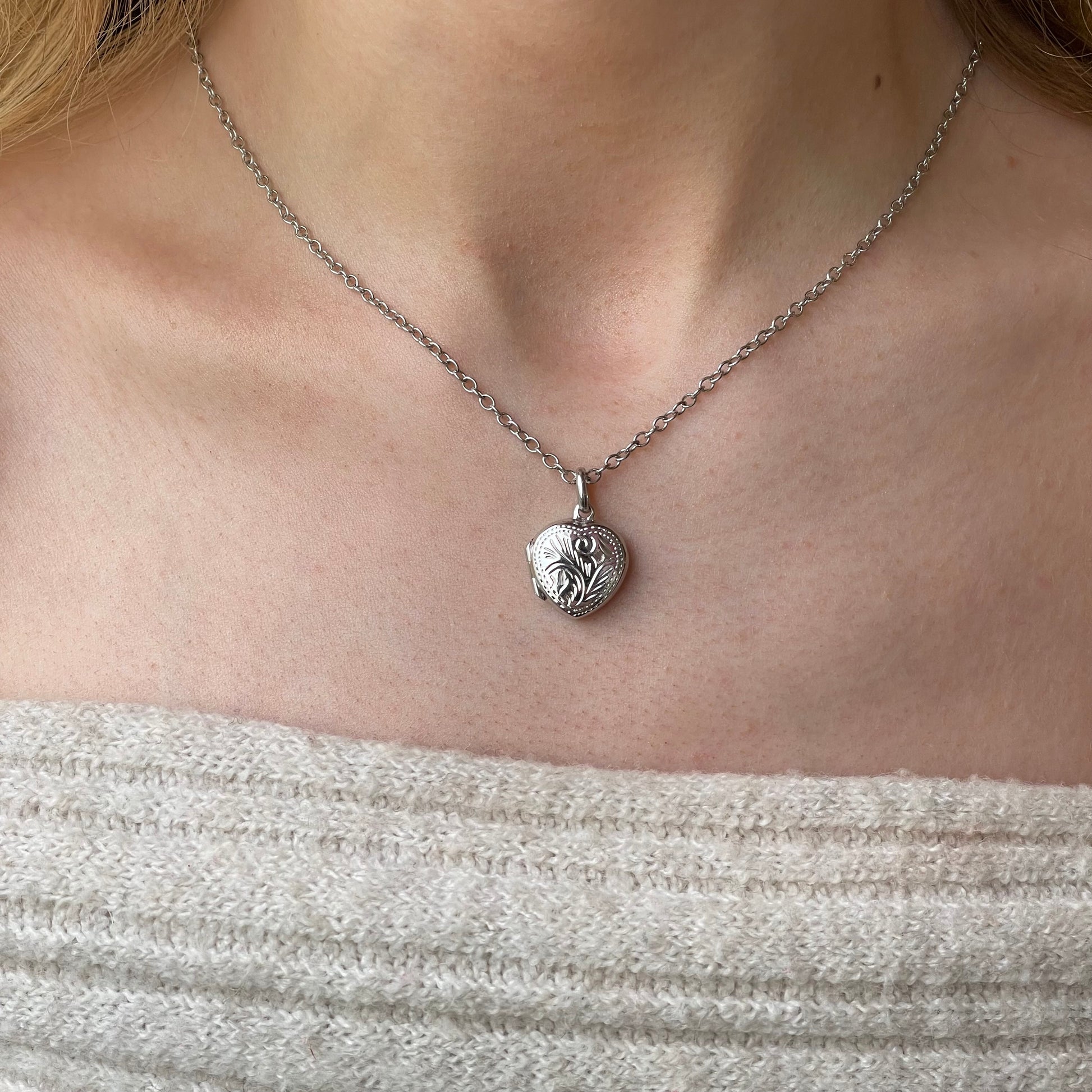 Silver engraved heart locket necklace with chain, featuring intricate design and polished finish, by Insignia.