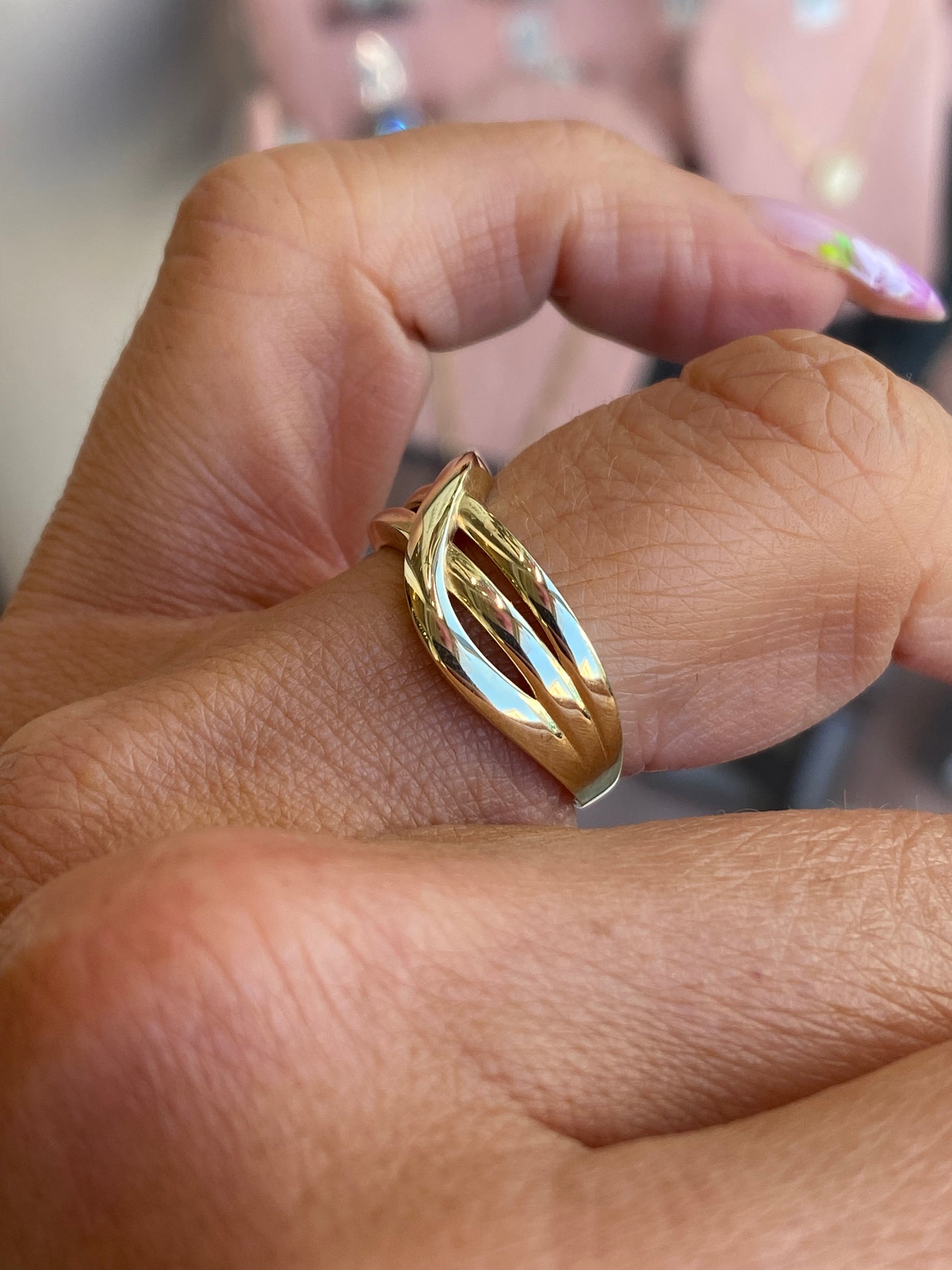 9ct gold crossover ring by NJO featuring elegant intertwined bands and a polished finish.