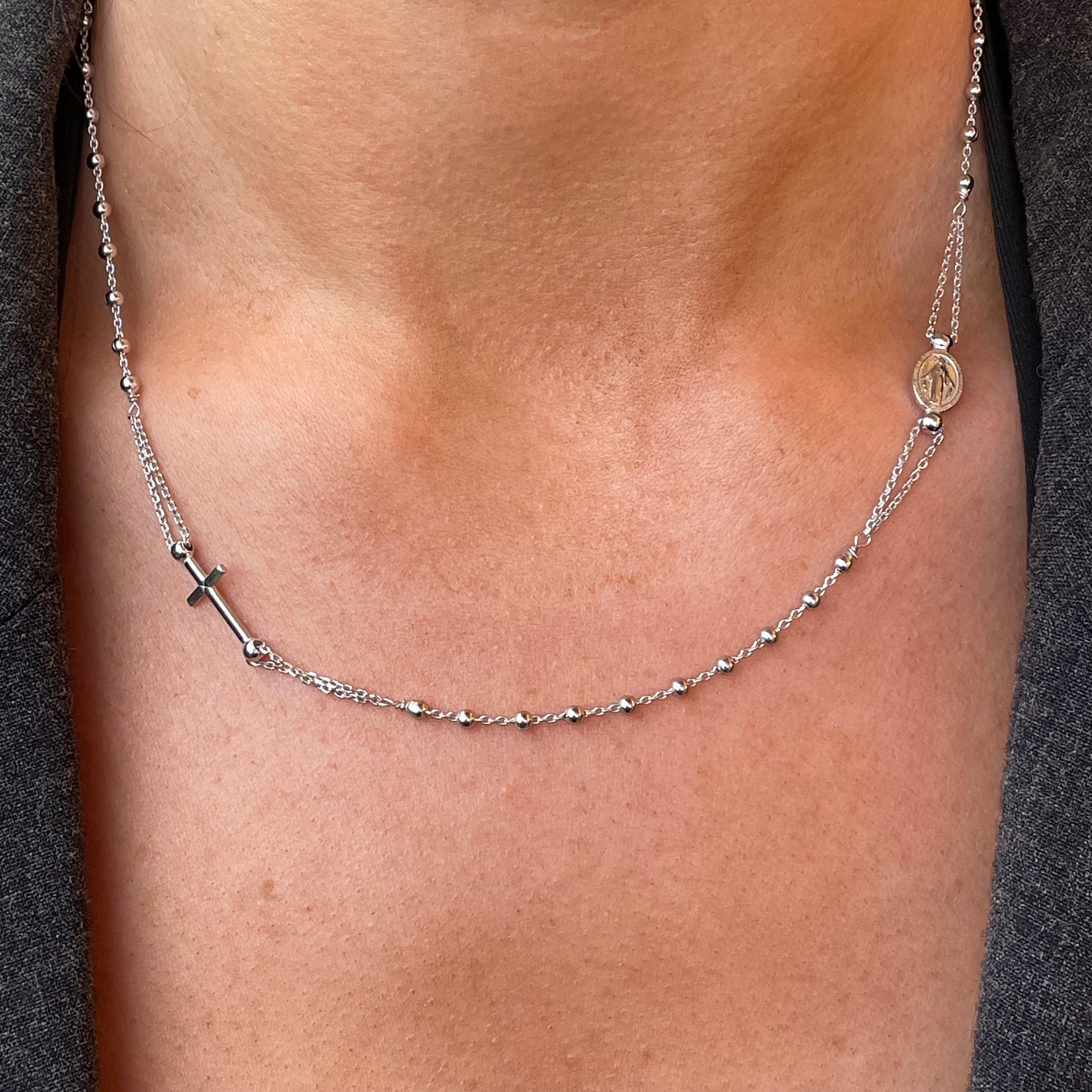 Silver rosary necklace with 45cm chain from Comero, featuring detailed bead and cross design.