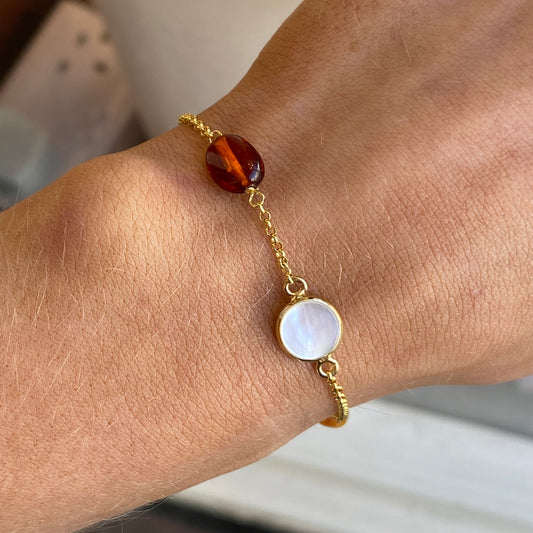 Bruno amber and mother of pearl bracelet with mixed beads and a silver clasp on a white background.