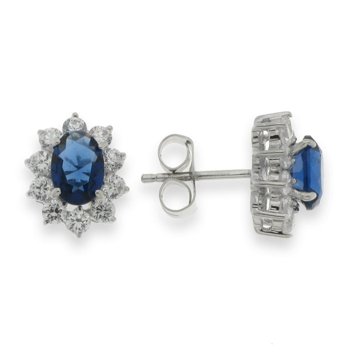 Silver oval CZ Diana stud earrings with sapphire blue stones by Comero, featuring elegant, sparkling gemstone accents.