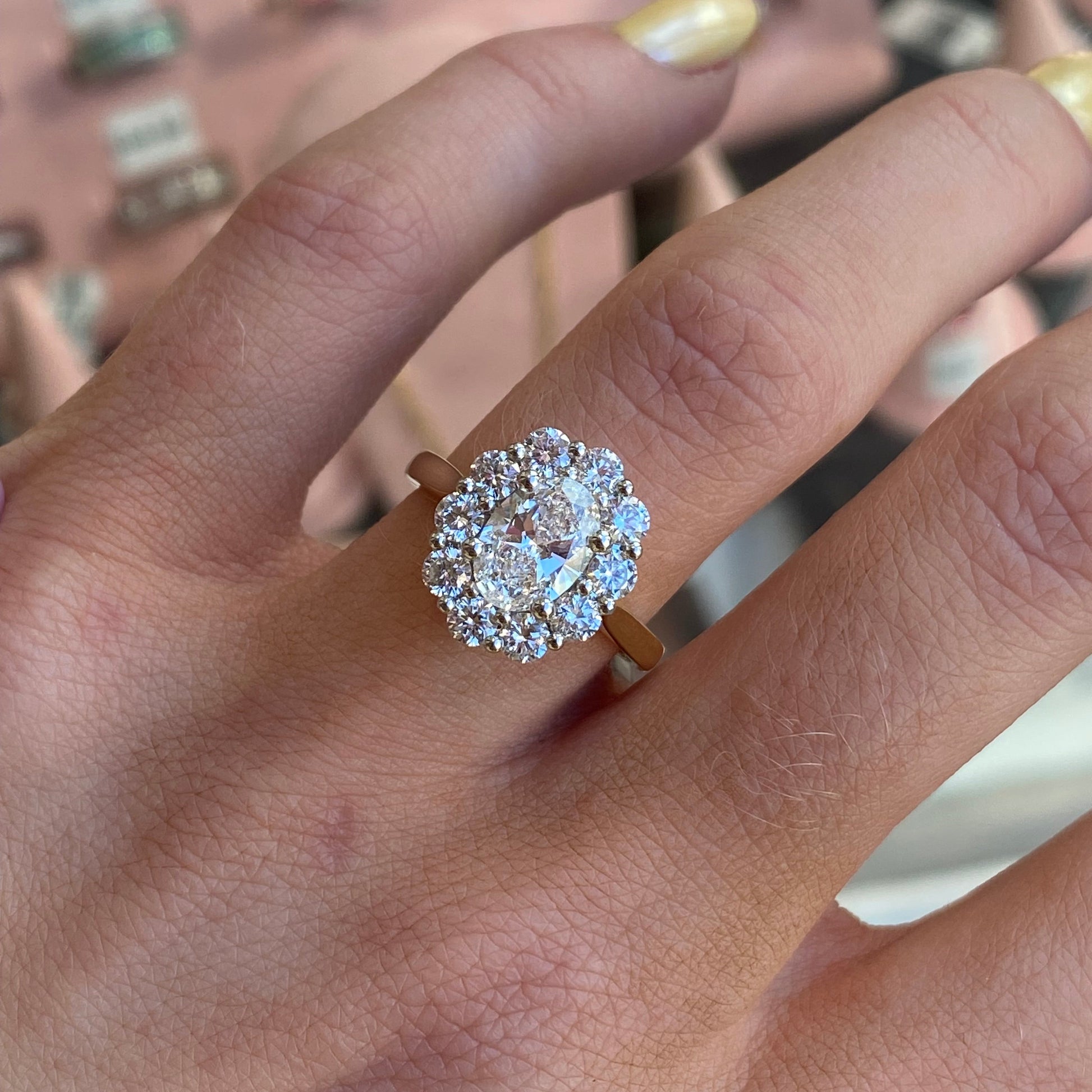 Prima 18ct gold oval cluster engagement ring with a certificated lab, featuring a detailed oval cluster design on a gold band