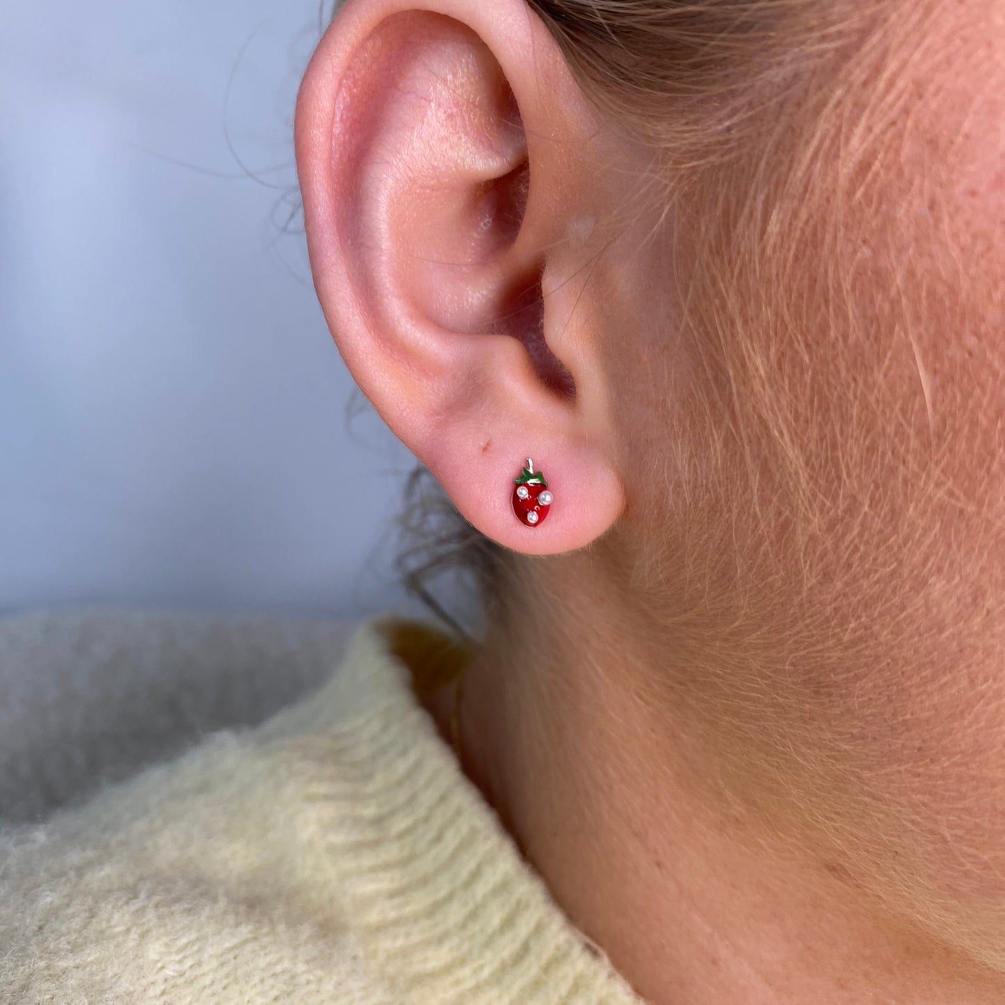 Silver strawberry enamel kid's earrings by Comero featuring cute strawberry design and silver stud style.
