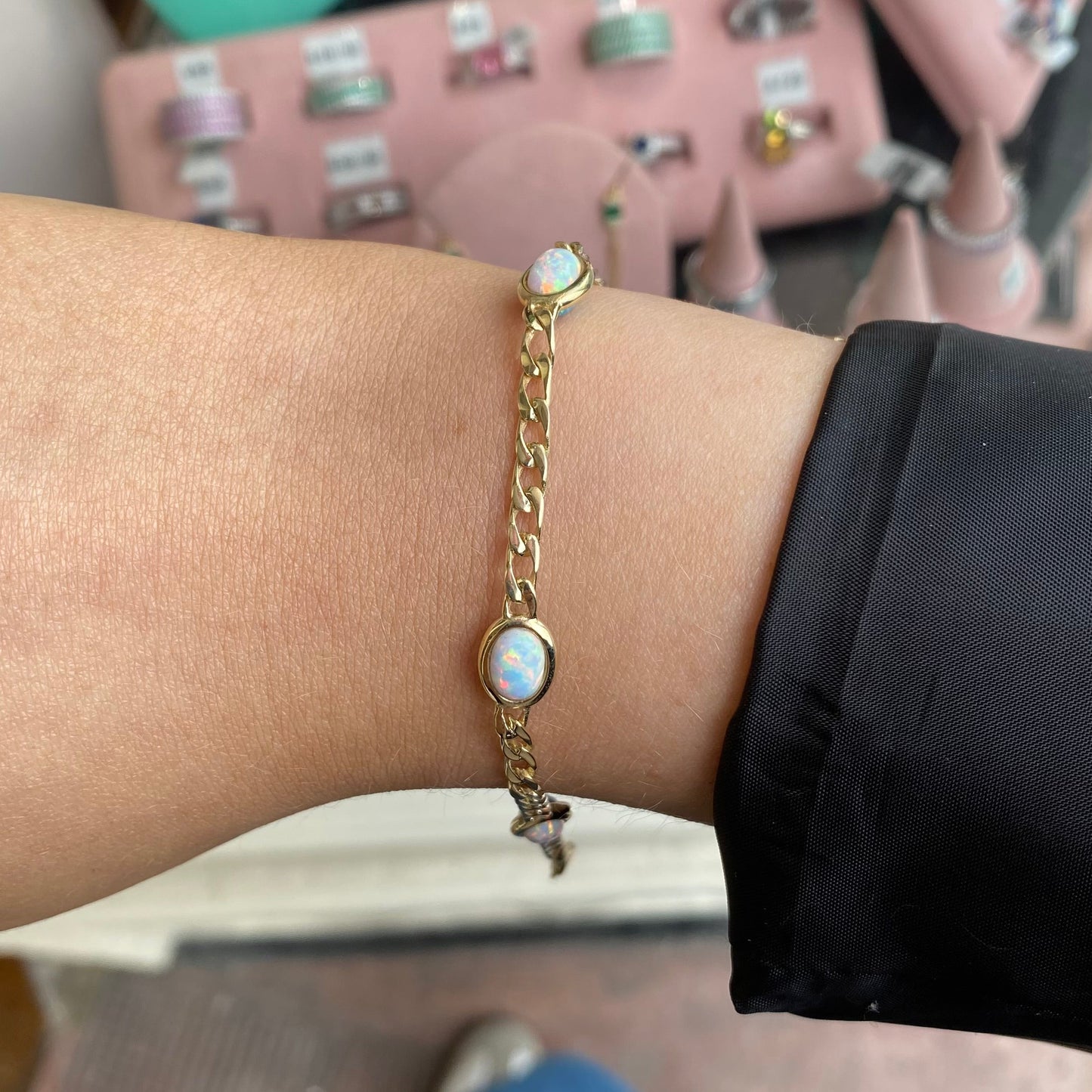 Reversible PJD 9ct gold bracelet with blue and white Opalique gemstones, showcasing intricate design and elegant craftsmanship.