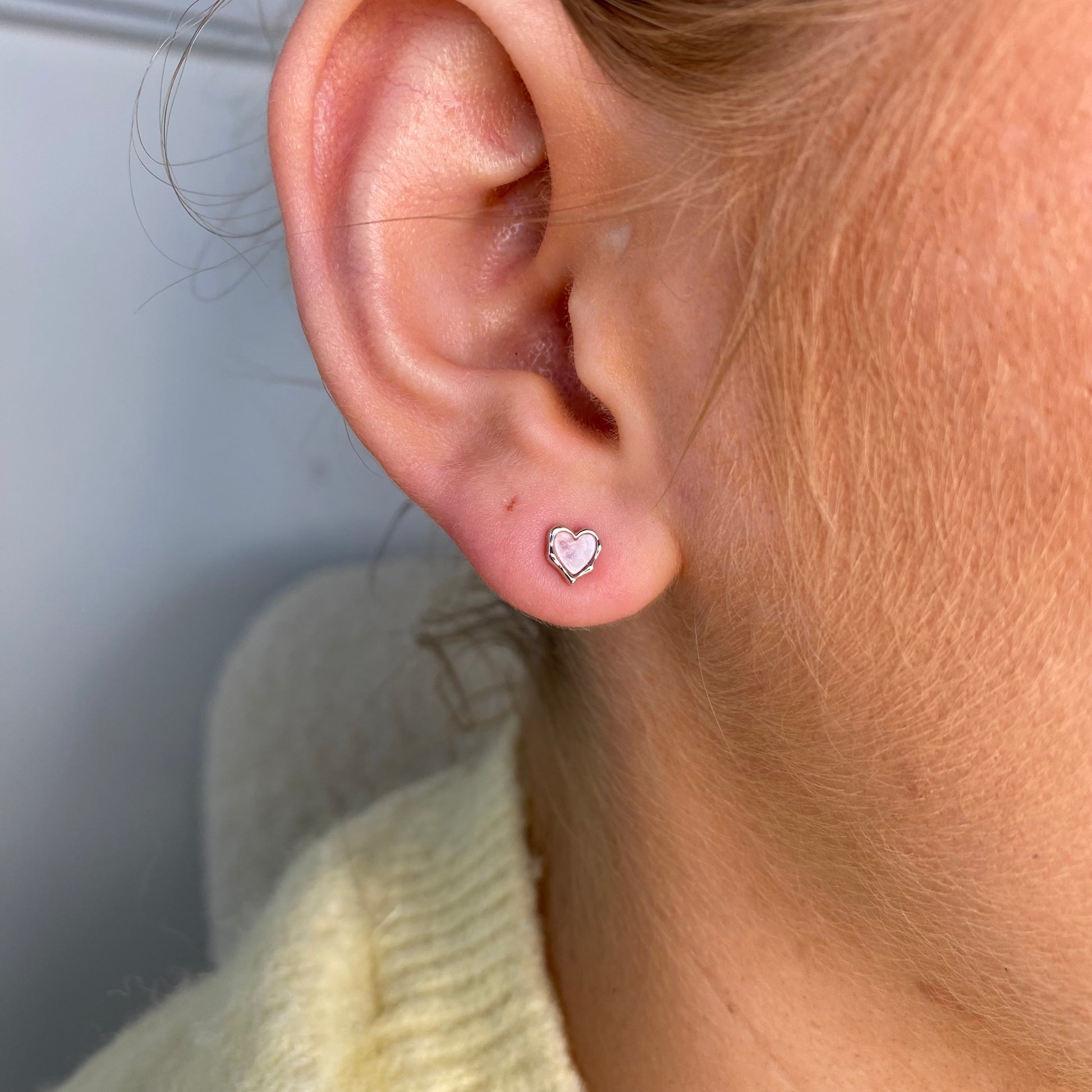 Silver enamel heart stud earrings for kids in pink, by Comero, featuring cute heart shapes and shiny silver finish.