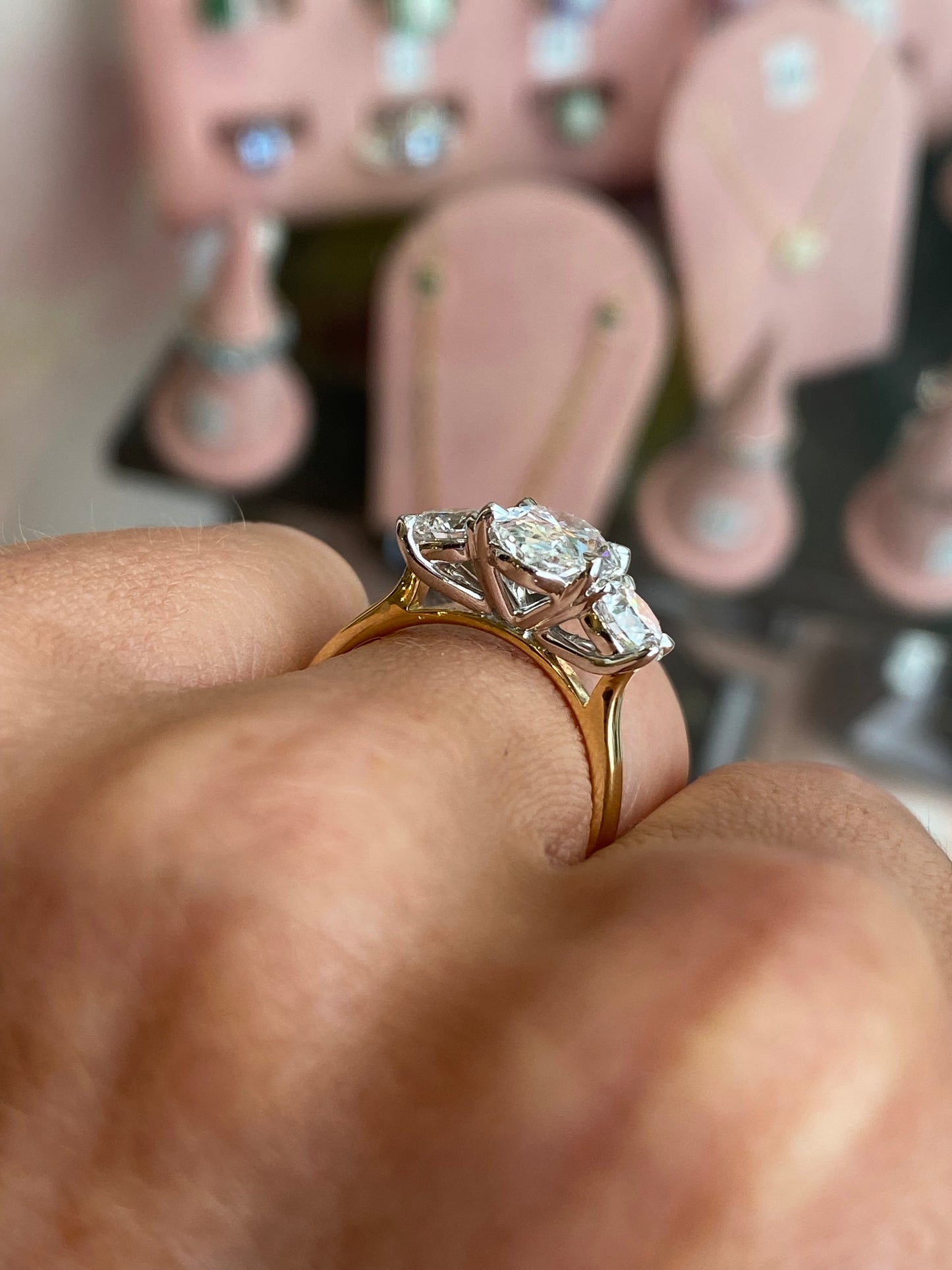 18ct gold oval trilogy engagement ring with three lab-certified diamonds totaling 3.15ct, featuring a classic and elegant design by TCA.