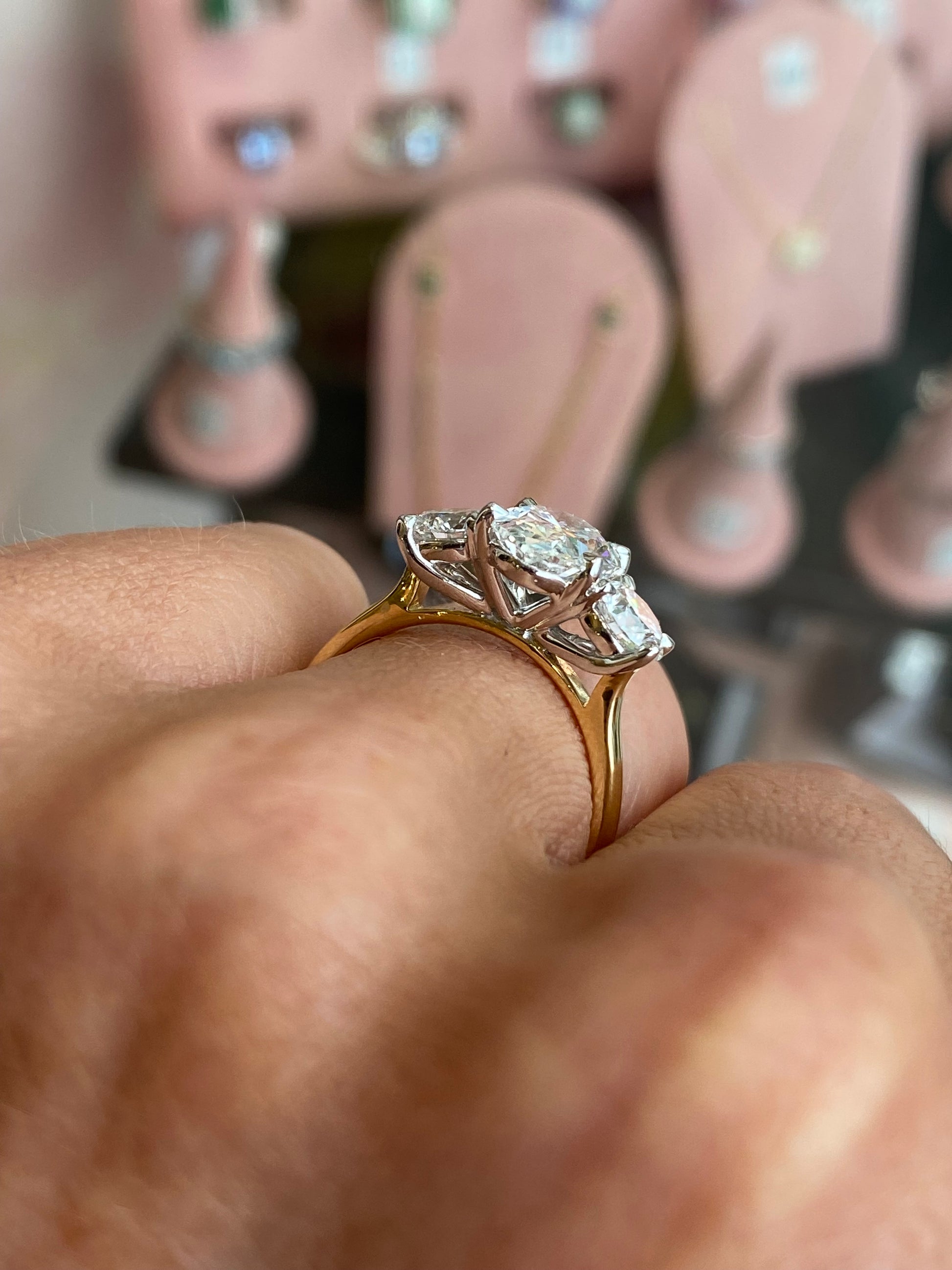 18ct gold oval trilogy engagement ring with three lab-certified diamonds totaling 3.15ct, featuring a classic and elegant design by TCA.