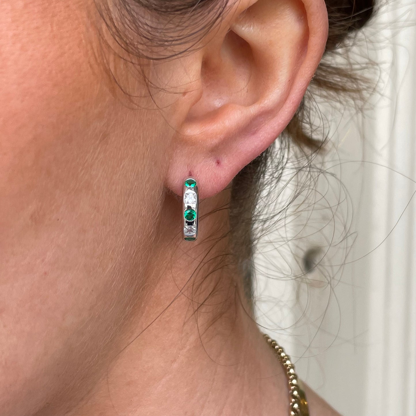Silver green CZ hoop earrings by Comero featuring sparkling green cubic zirconia and sleek silver hoops.