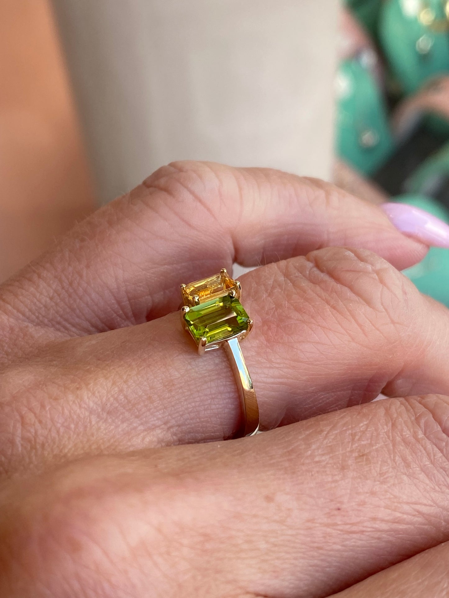 Insignia 9ct gold Moi Et Toi ring featuring a citrine and peridot gemstones, displayed with intricate gold band details.