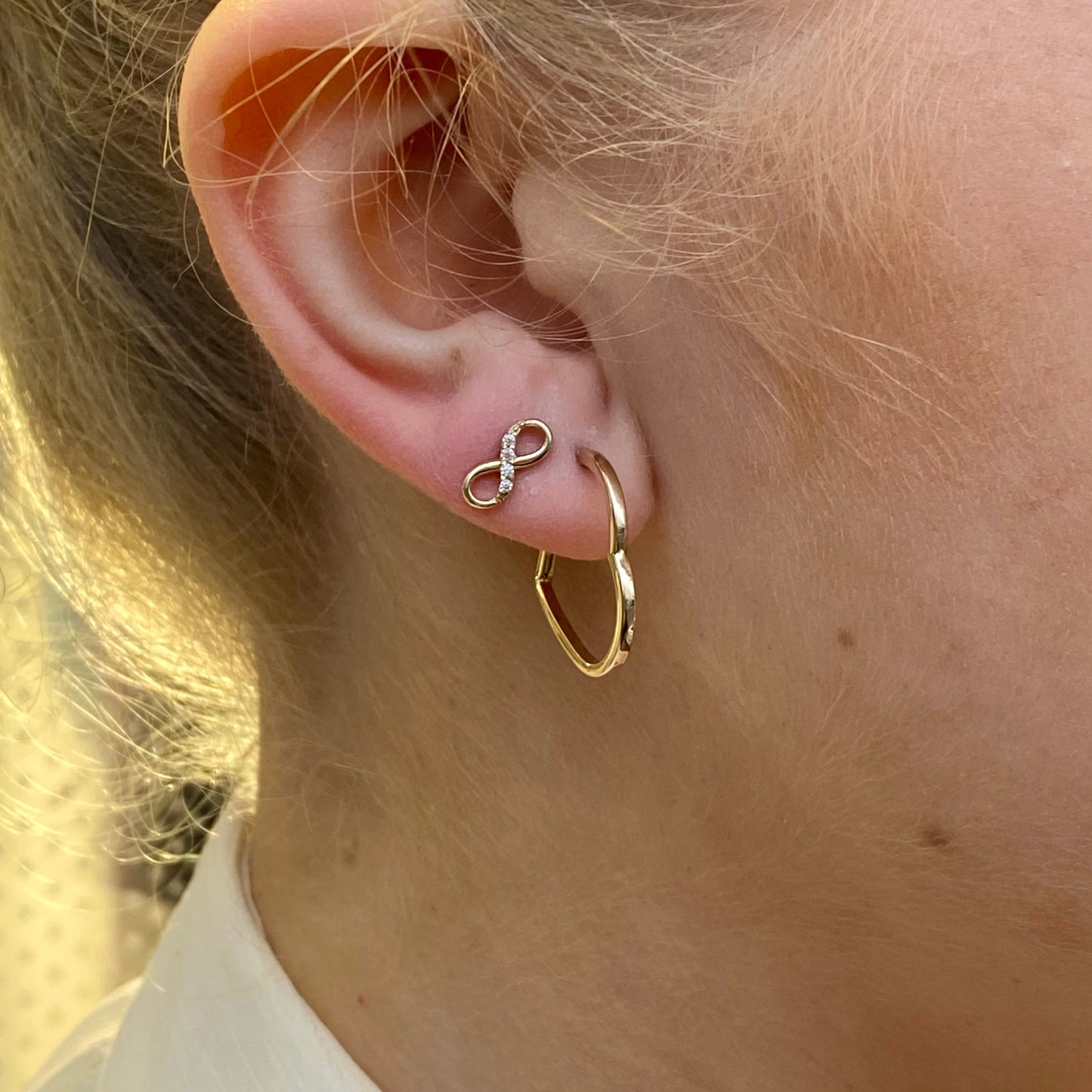 NJO 9ct gold CZ infinity stud earrings featuring sparkling cubic zirconia and a sleek infinity design for elegant style.