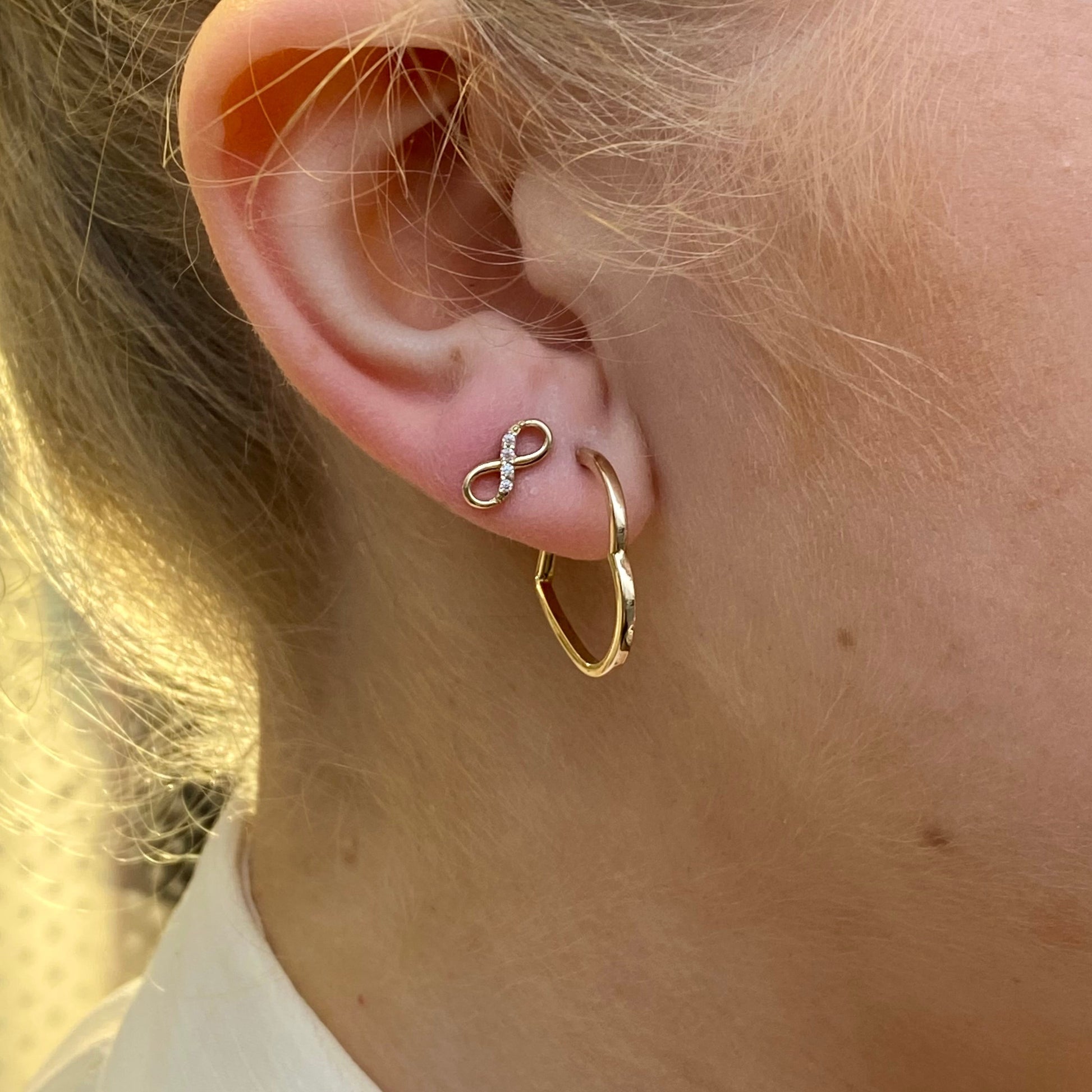 NJO 9ct gold CZ infinity stud earrings featuring sparkling cubic zirconia and a sleek infinity design for elegant style.