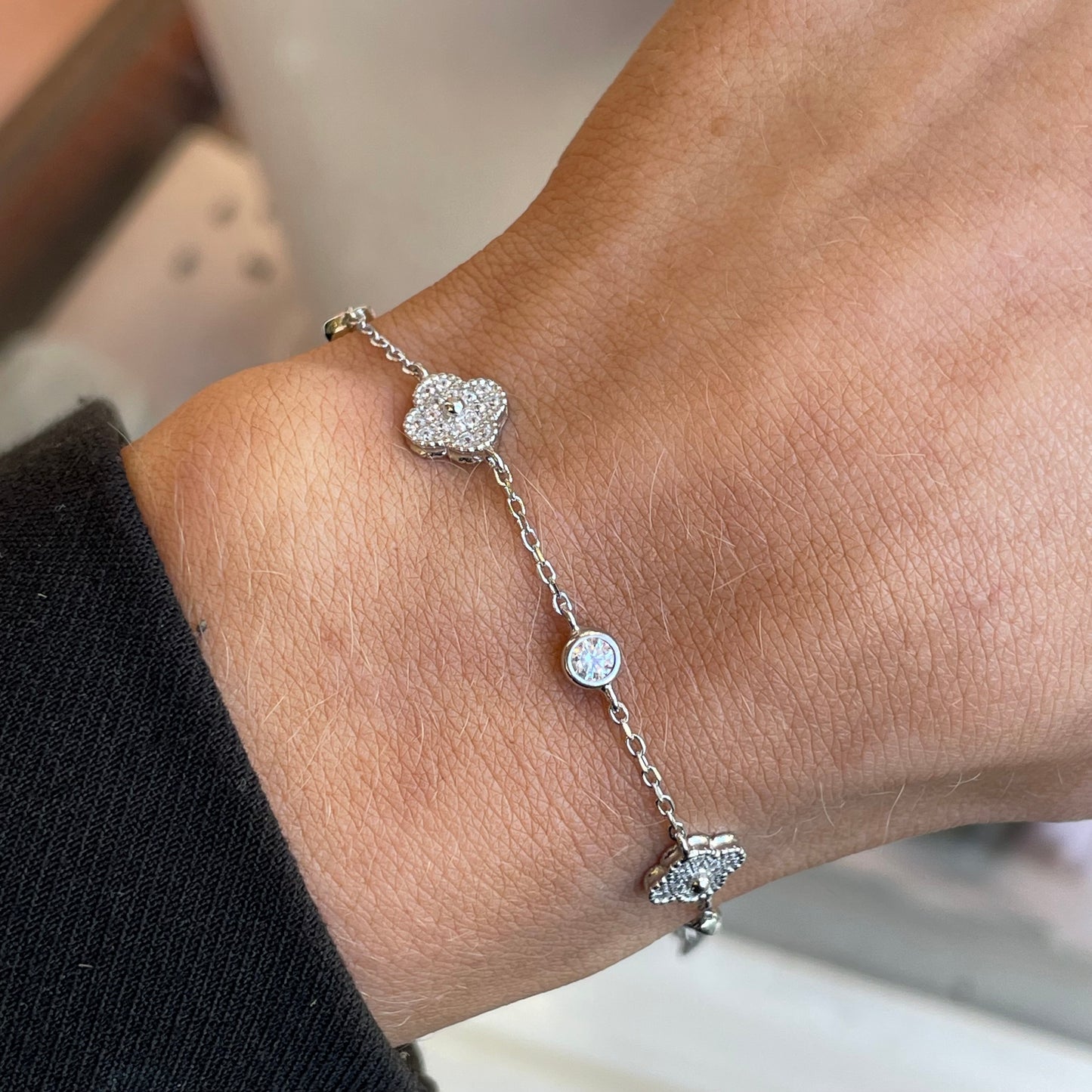 Silver CZ quatrefoil bracelet by Insignia featuring sparkling cubic zirconia stones and a delicate chain design.
