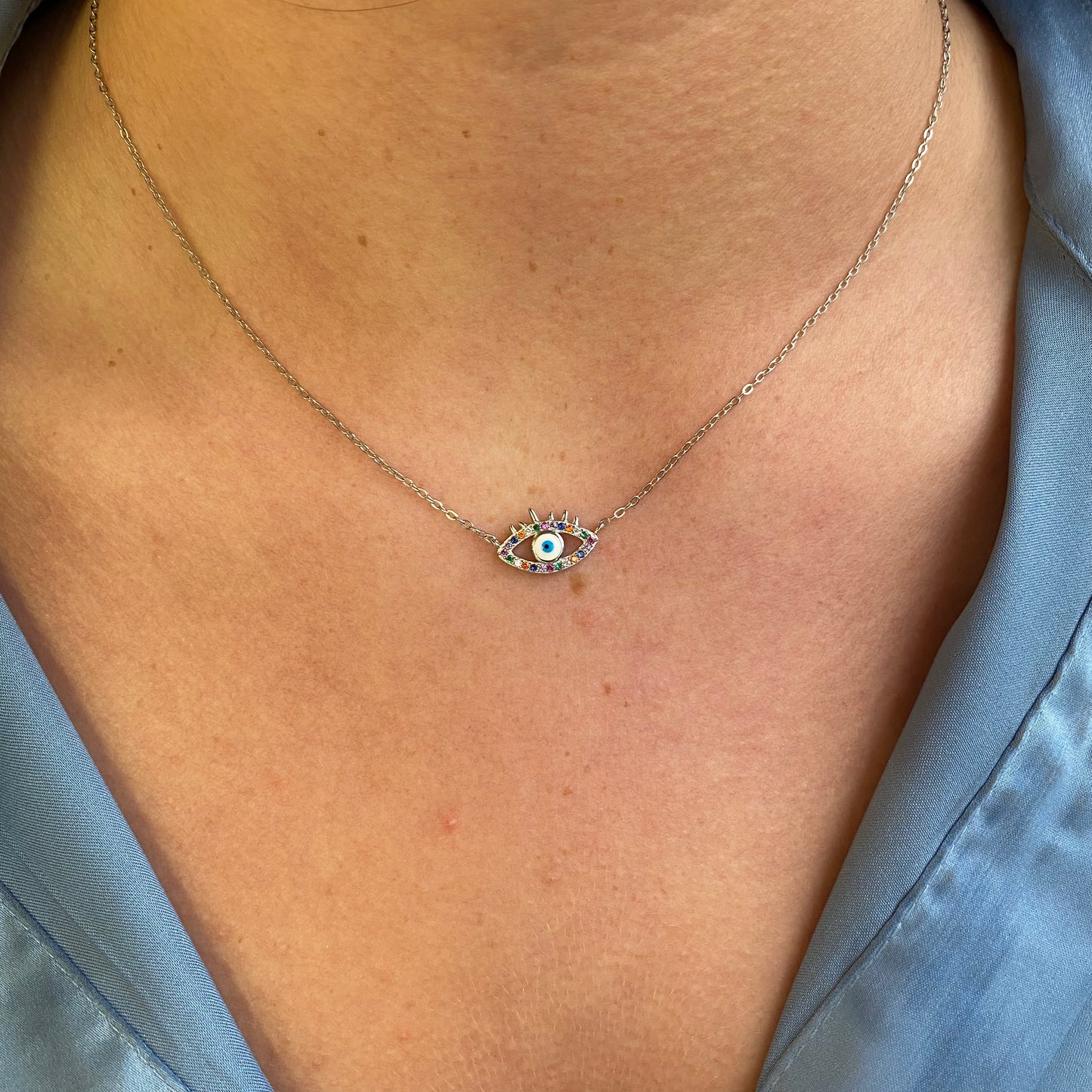 Silver Colours Evil Eye Necklace by Comero featuring a detailed evil eye pendant on a sleek silver chain.