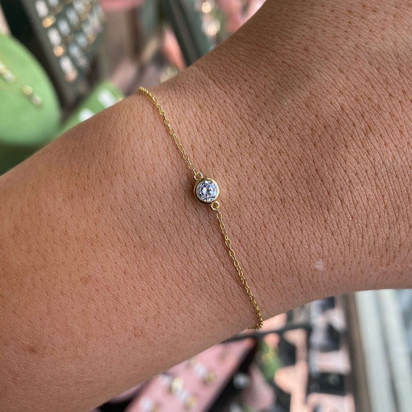 CME Sunshine CZ Solitaire Bracelet featuring sparkling cubic zirconia stones on a delicate chain, elegant jewelry accessory.