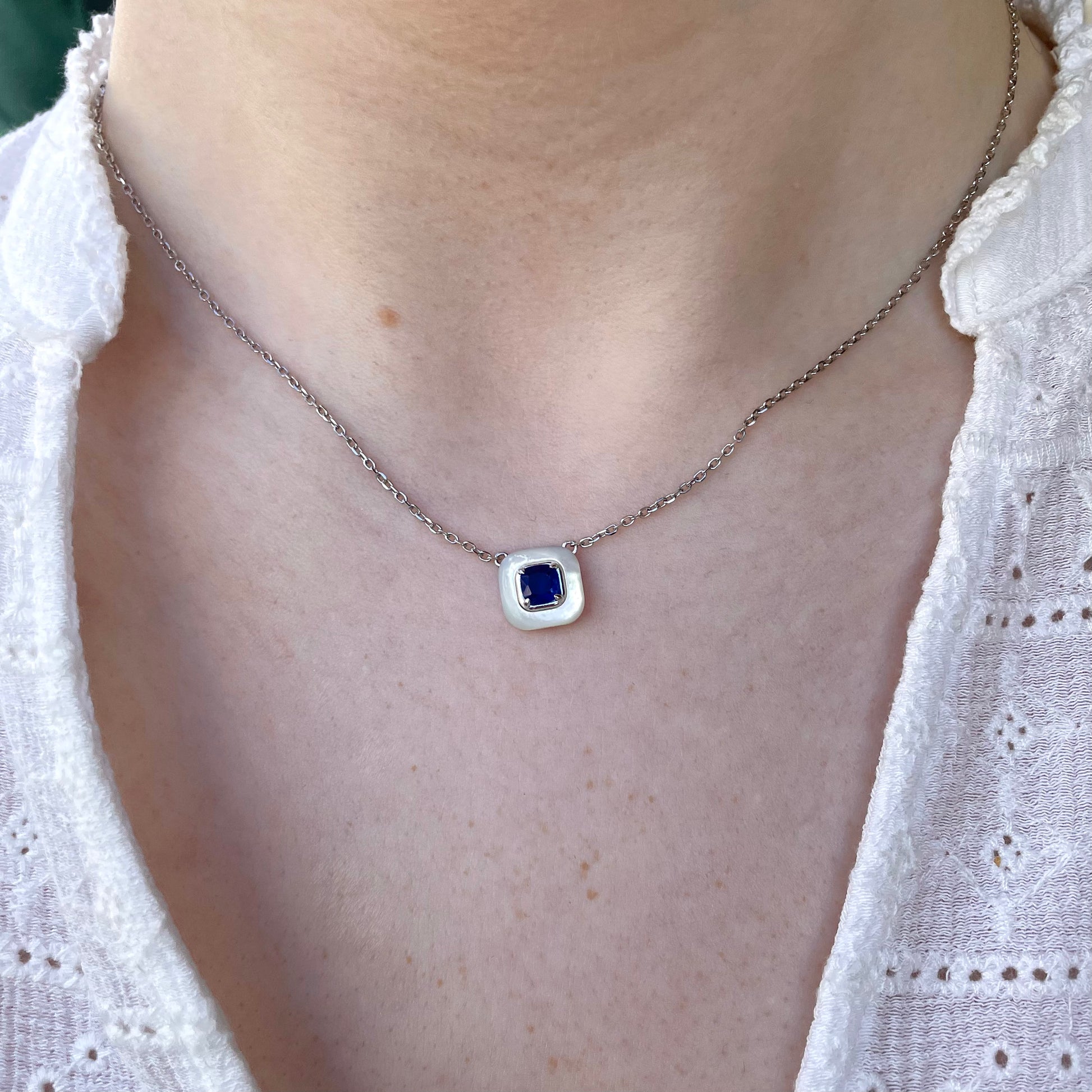 Silver sapphire blue and faux mother of pearl necklace by Comero, featuring elegant gemstone and pearl accents.