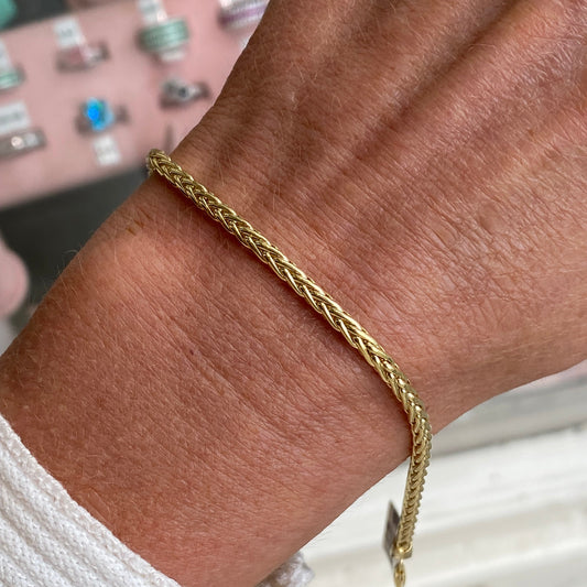 9ct gold Palmier bracelet by Mark Milton featuring intricate leaf-shaped design on a delicate gold chain.