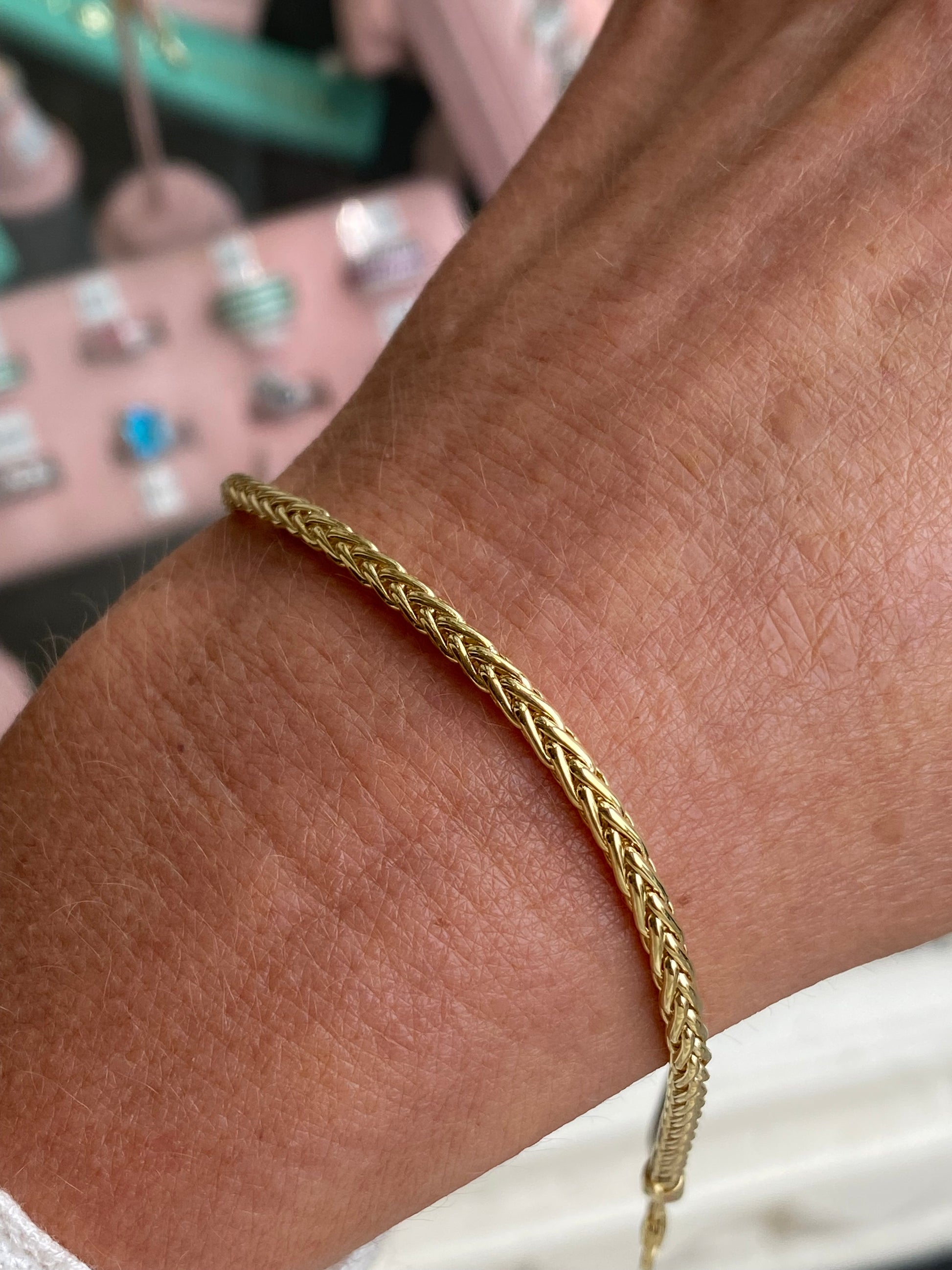 9ct gold Palmier bracelet by Mark Milton featuring intricate leaf-shaped design and secure clasp on a white background.