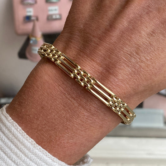 9ct gold three bar gate bracelet by Mark Milton, featuring a sleek, polished design with interconnected bars on a delicate chain.
