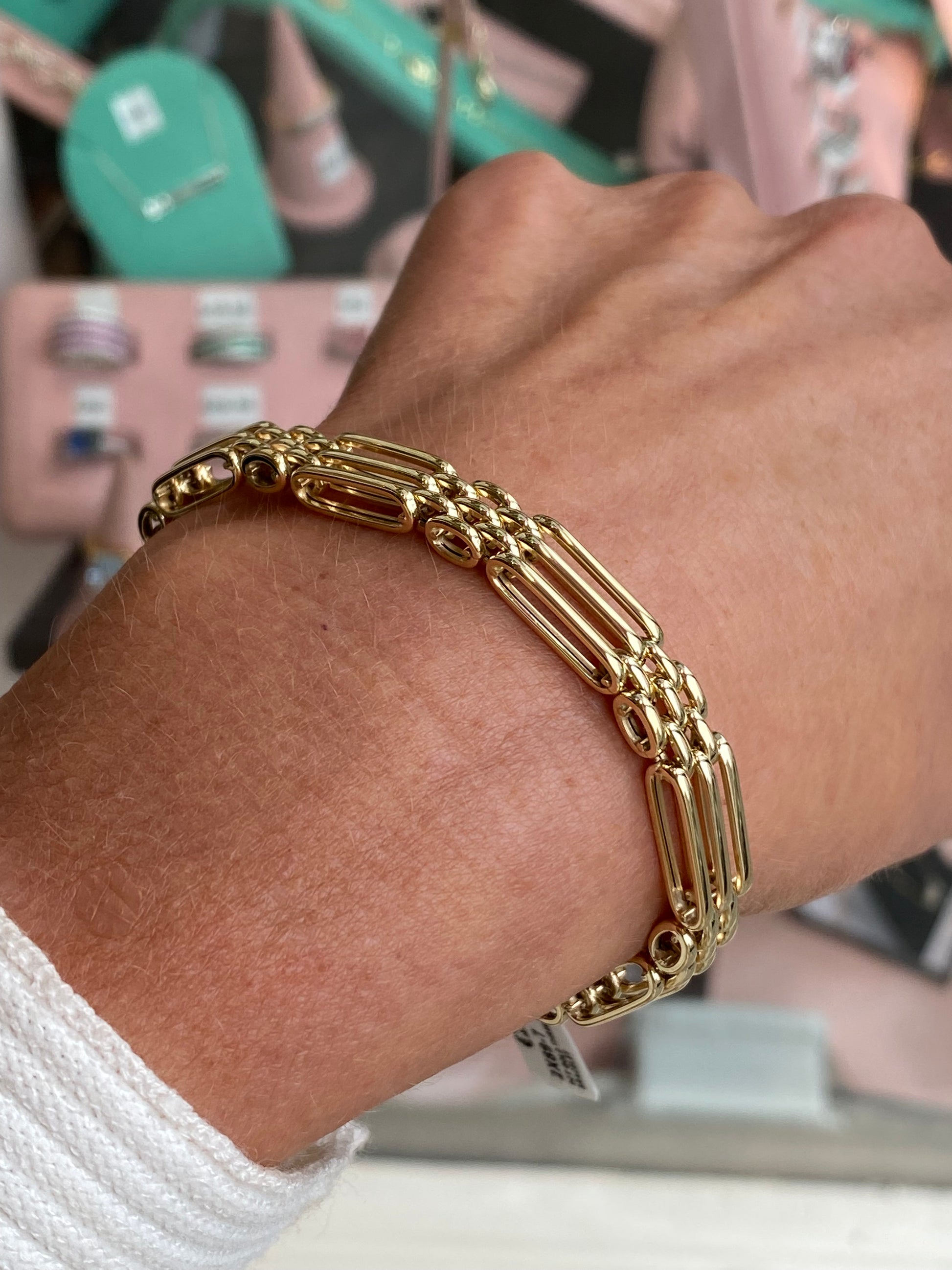 9ct gold three bar gate bracelet by Mark Milton, showcasing polished gold bars connected with secure links.
