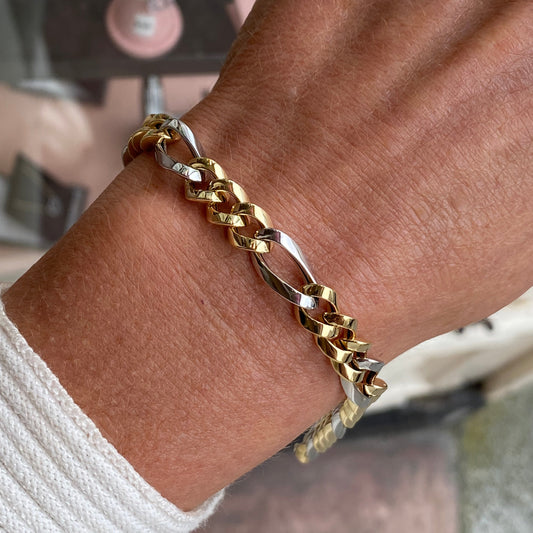 Close-up of a 9ct gold two-tone chunky Figaro bracelet by Mark Milton, showing its layered chain links and polished finish.