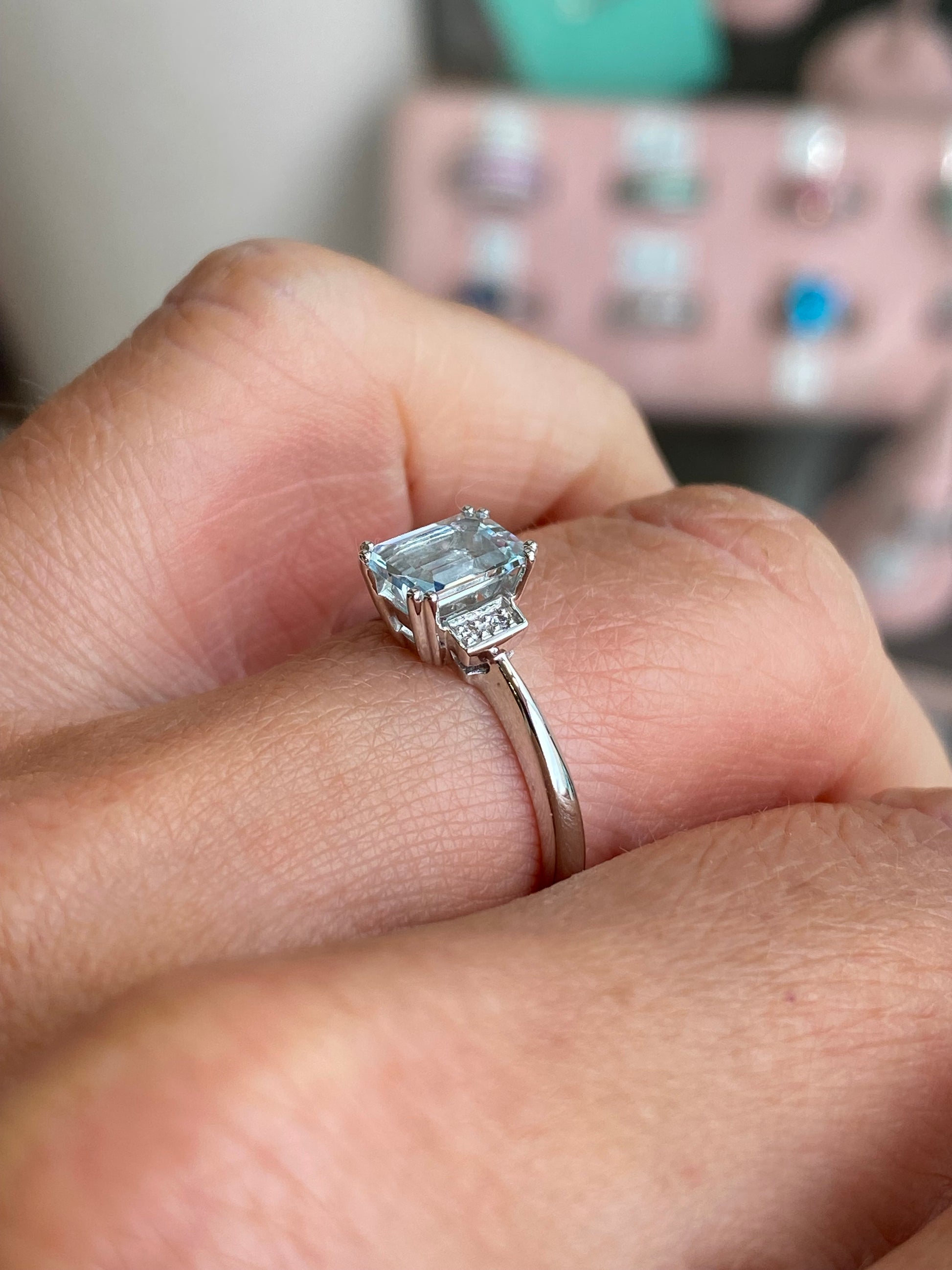 9ct white gold aquamarine and diamond ring by Mark Milton, featuring a large central aquamarine gemstone and sparkling side diamonds.