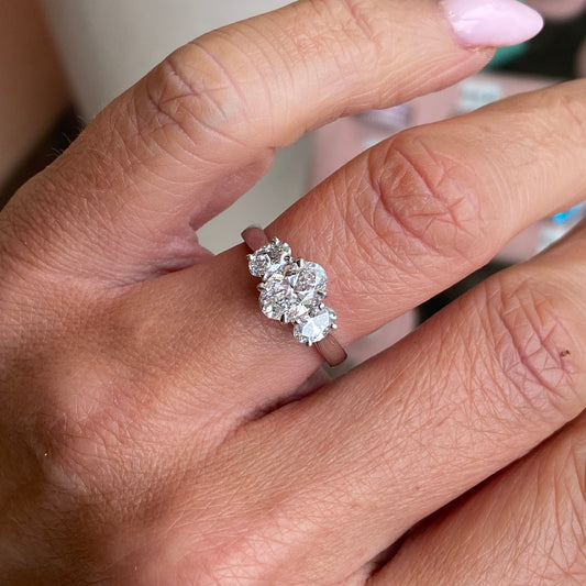 TCA platinum oval trilogy engagement ring with 1.59ct lab-certified diamonds, showcasing a sleek and elegant design.