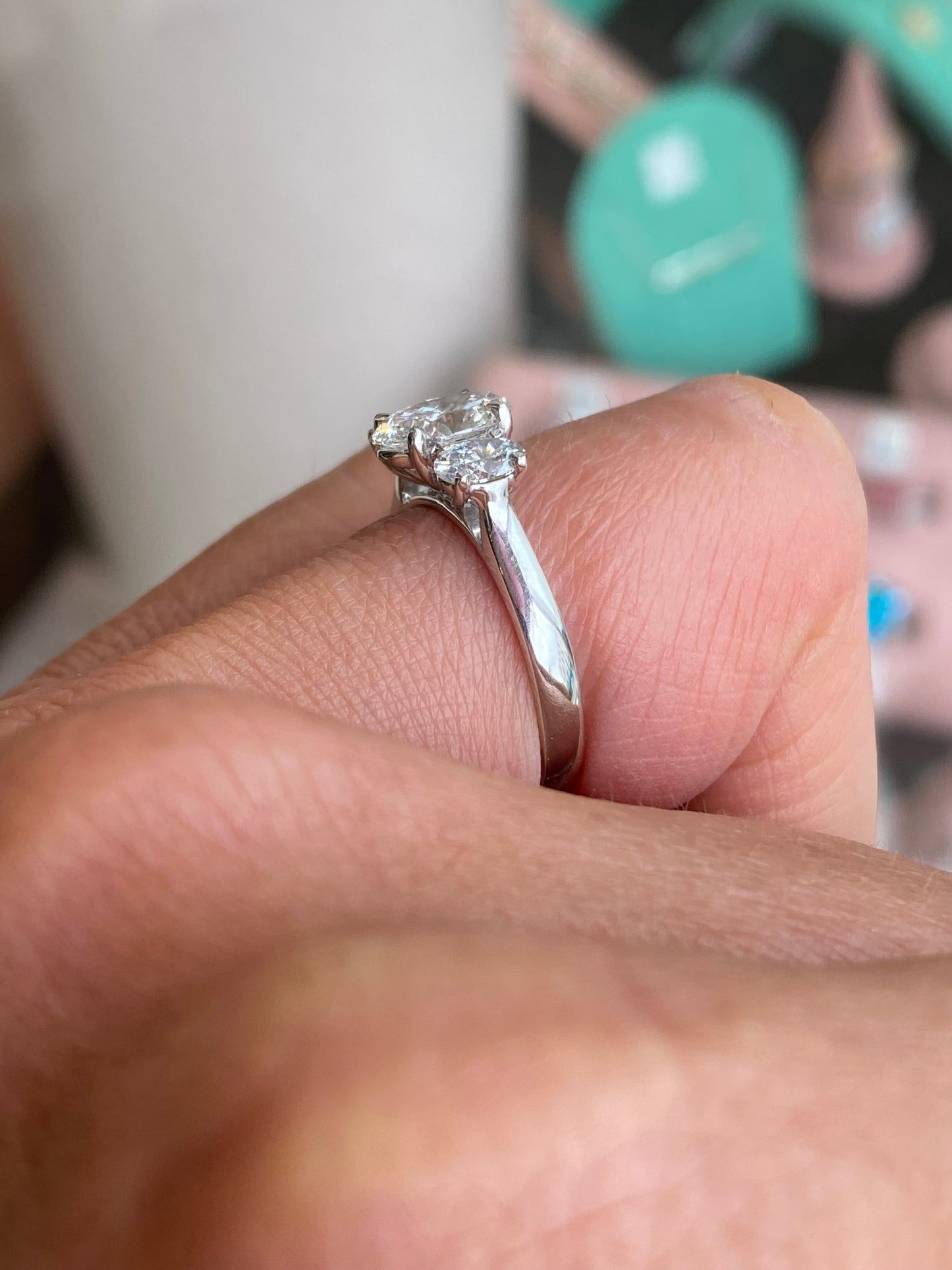 Lab-certified platinum oval trilogy engagement ring with 1.59ct center stone and side accents, showcasing elegant craftsmanship.