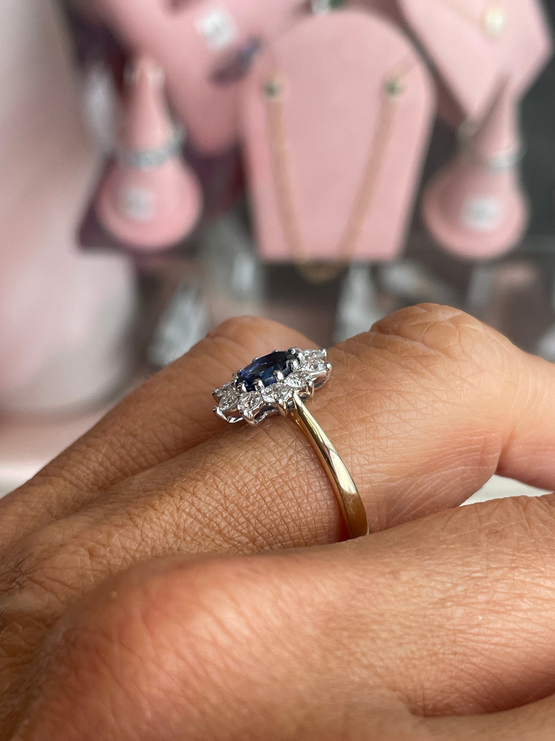 9ct gold lab-grown oval sapphire cluster ring with five by seven millimeter stones, crafted by PJD.