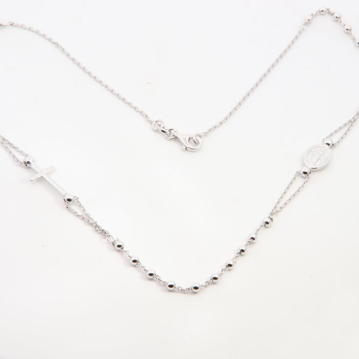 Silver rosary necklace by Comero, 45cm length featuring detailed religious beads and a central cross pendant.