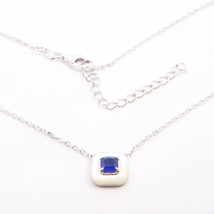 Silver sapphire blue and faux mother of pearl necklace by Comero, featuring a elegant pendant with shimmering gemstones and intricate design.