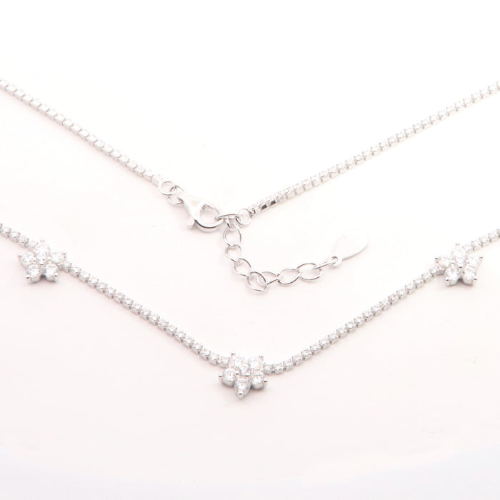 Silver floral CZ fringe necklace by Comero showcasing intricate floral design and dangling CZ accents on a 42+3cm chain.