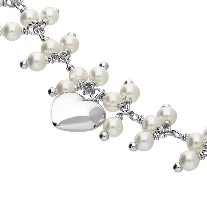 Silver faux pearl and heart bracelet by CME featuring elegant design with faux pearls and heart accents.