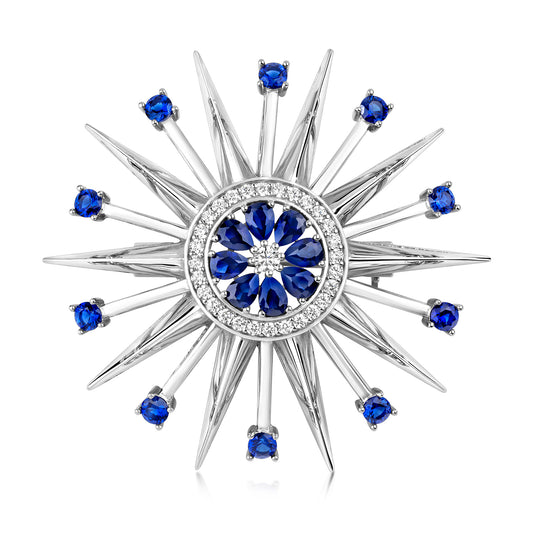 Silver sapphire blue CZ star burst brooch by THC featuring sparkling gemstone accents and intricate metalwork design.
