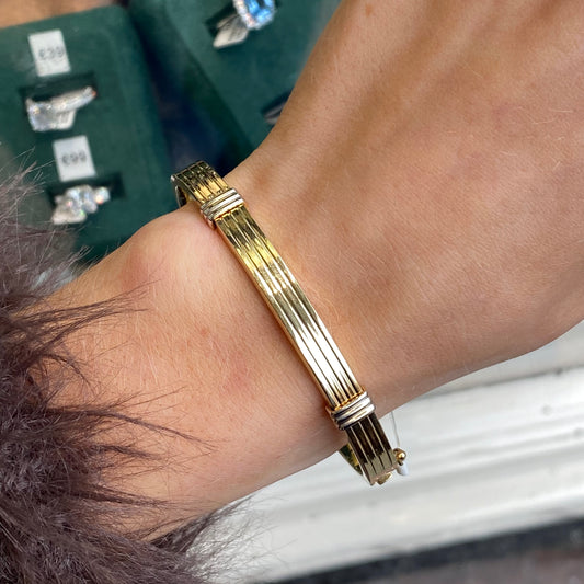 Mark Milton 9ct gold two-tone ribbed polished bangle on a white background