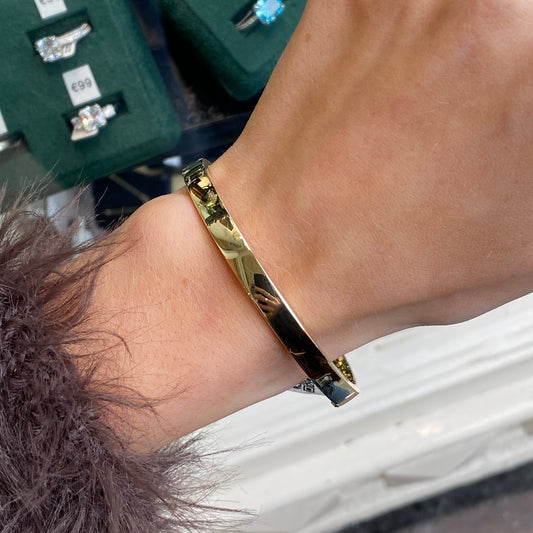 Mark Milton 9ct gold square edged polished bangle in a sleek, reflective finish