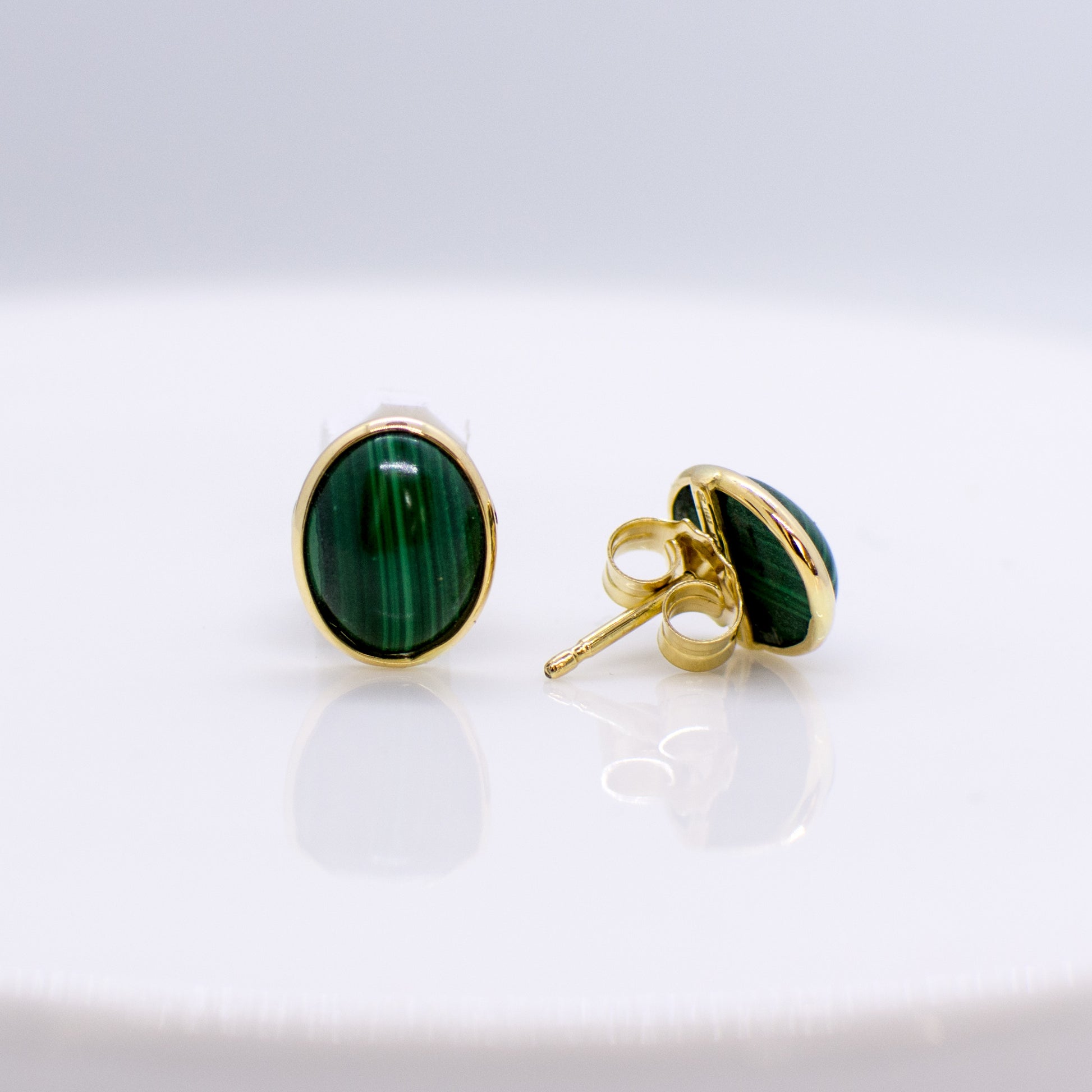 10mm x 8mm Malachite 18ct yellow gold Glowing combinations of cultured pearls, natural stones and gold are the focus of our Natural Beauty collection.  These exquisite materials have natural imperfections that delight with their uniqueness. Each item from this collection is handmade and one off.  We can provide the same designs in a range of colours and alloys.  The product shown is the one that you would buy.  Natural materials like turquoise and cultured pearls have unique colour variations.