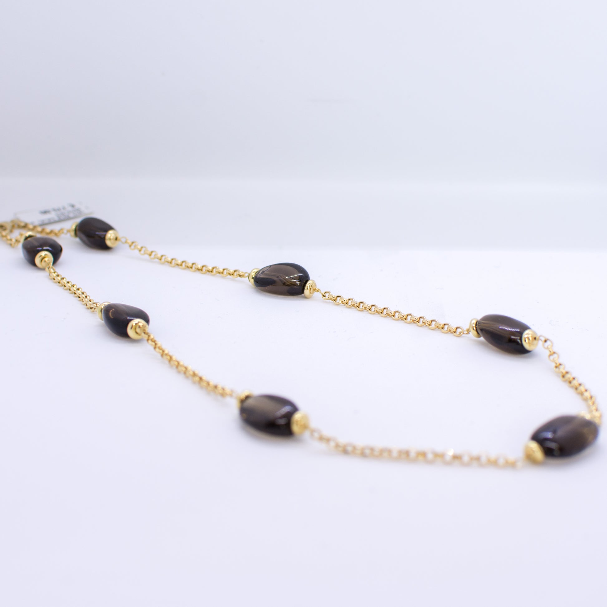 18ct Gold Smoky Quartz and Chain Necklace Smoky Quartz dimensions: 10mm x 12mm approximately Diamond cut 2mm gauge solid trace chain 45cm long 18ct yellow gold This item can be ordered in a variety of lengths.  Please contact us for custom requirements.