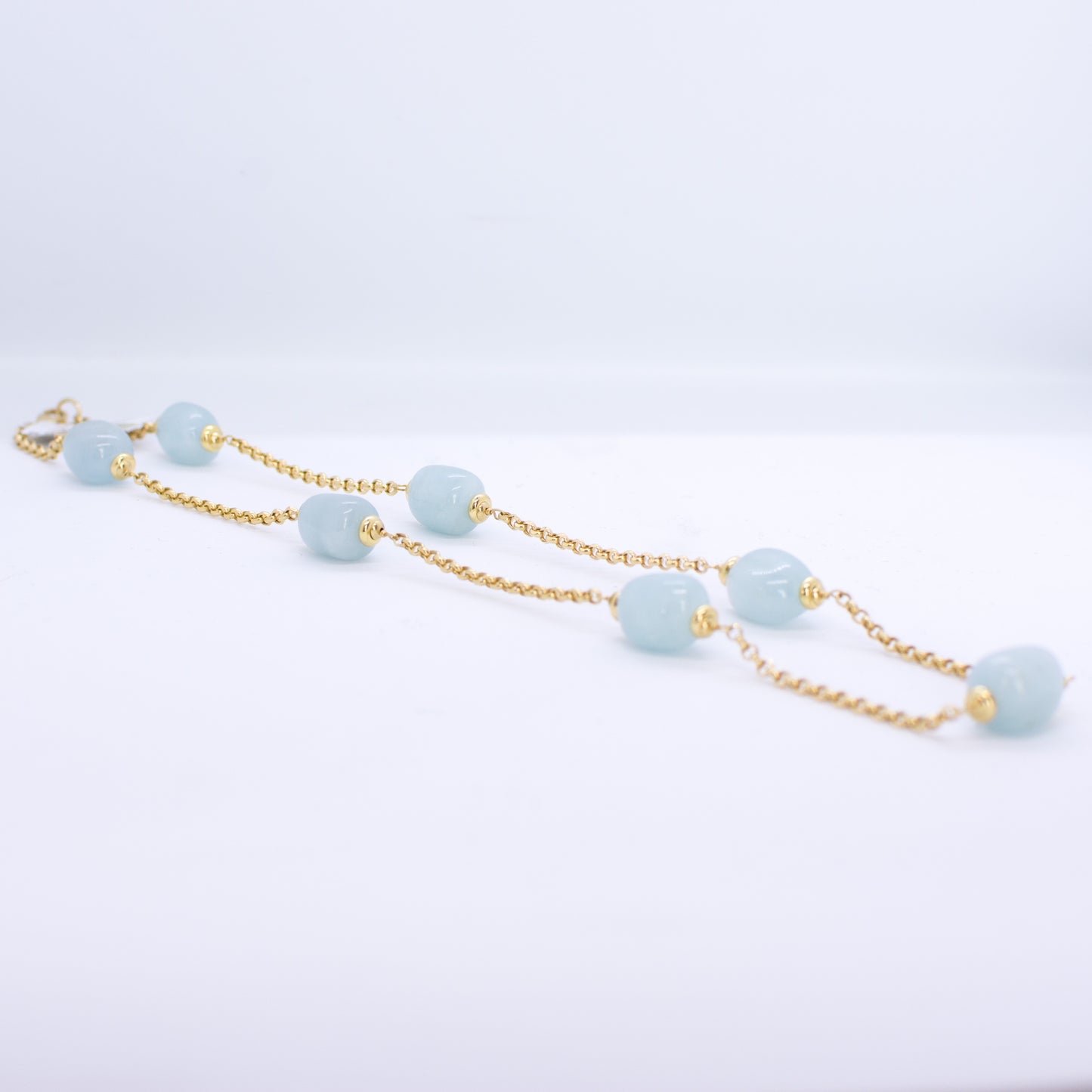 18ct Gold Silky Aquamarine and Chain Necklace Silky Aquamarine dimensions: 10mm x 12mm approximately Diamond cut 2mm gauge solid trace chain 45cm long 18ct yellow gold This item can be ordered in a variety of lengths.  Please contact us for custom requirements.