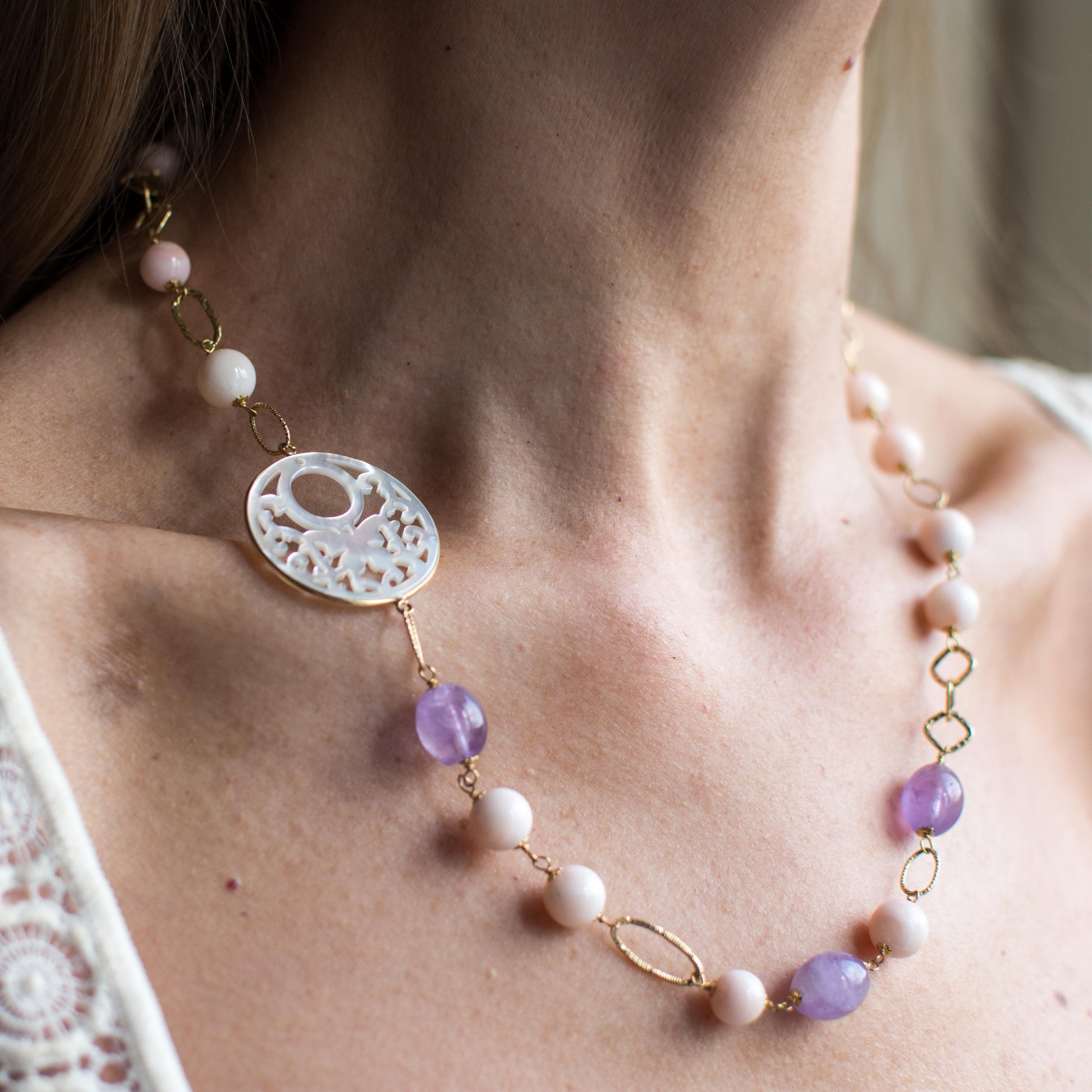 18ct Gold Mother of Pearl fancy cut out, Rose Coral bead and Silky Amethyst Necklace Asymmetrical pattern with the Mother of Pearl cut out positioned on the collarbone.  This necklace is hand made an features fancy round, oval and square links. 52cm necklace 18ct yellow gold