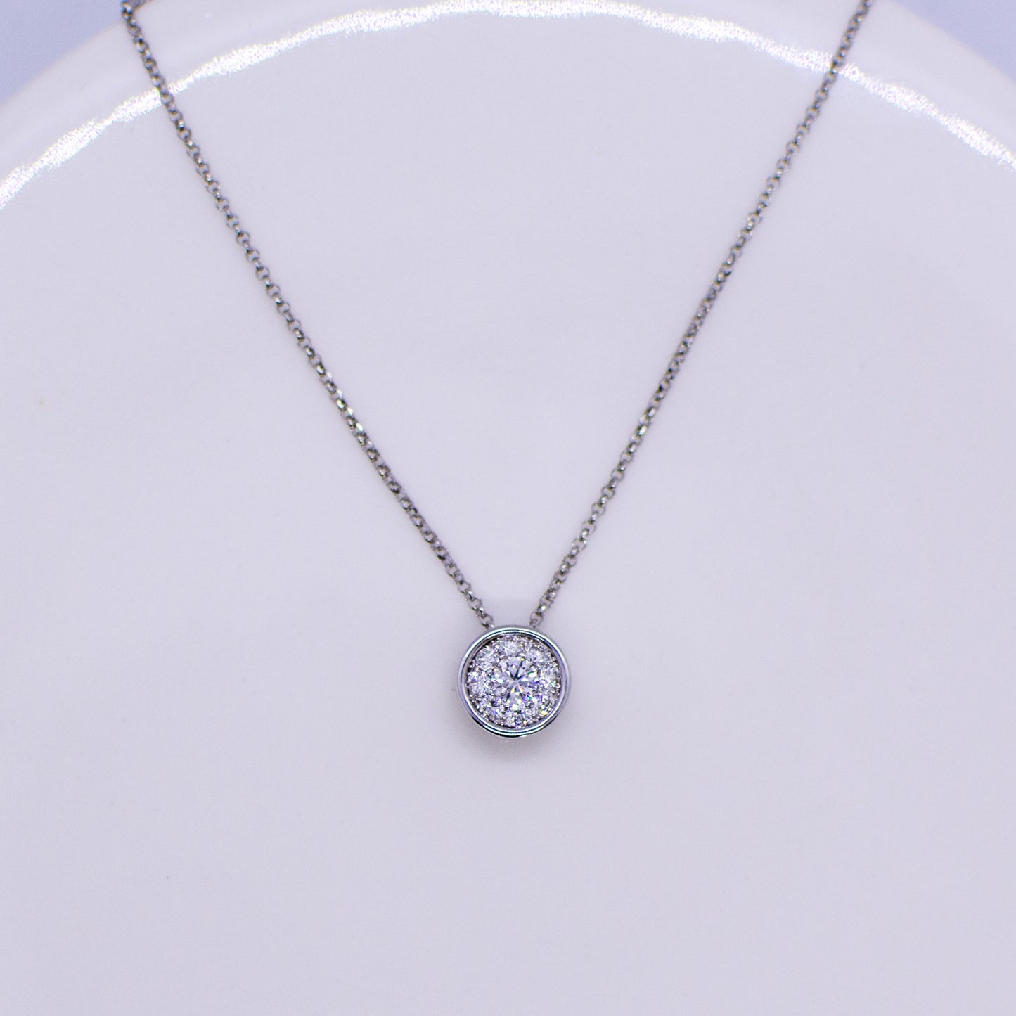 This diamond slider necklace is fabulous choice if you are looking for a super wearable diamond set necklace. A cluster of round brilliant cut diamonds gives a solitaire look.  0.35ct GVS in total approximately.  18ct white gold.  The chain passes through the pendant.  42cm-45cm adjustable 18ct white gold fine diamond cut belcher chain with lobster clasp.