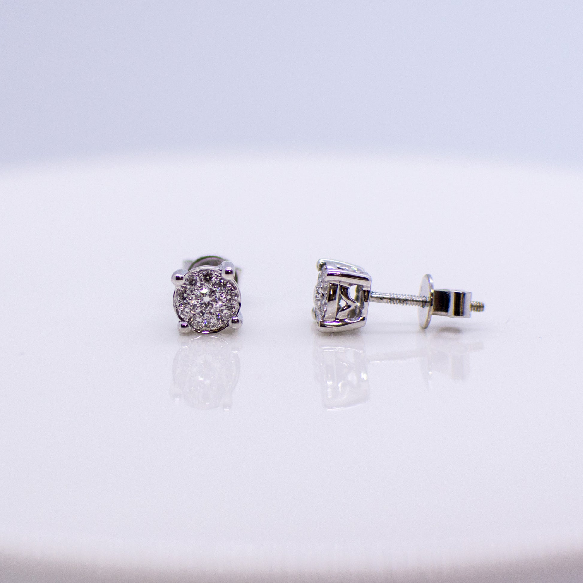 5.5mm wide 18ct white gold diamond stud earrings. 0.25ct of round brilliant cut diamonds.  Illusion setting.  18ct white gold.   Screw on butterfly backs.