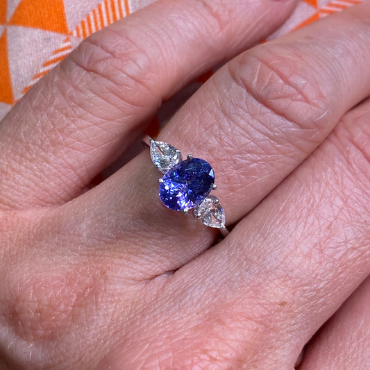 18ct White Gold Tanzanite & Diamond Ring  Oval cut Tanzanite 1.55ct  Two pear cut diamonds: 0.45ct in total